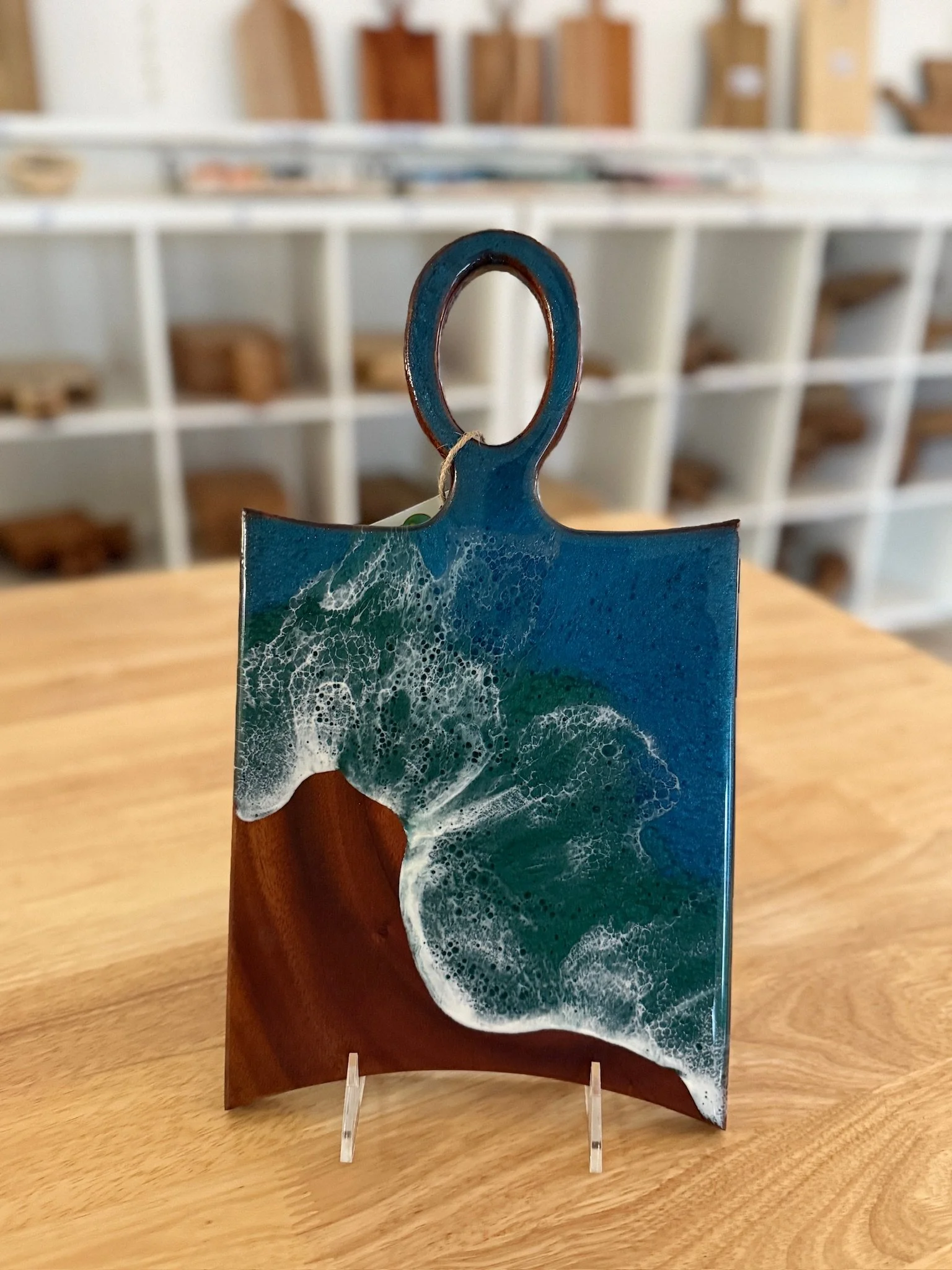 Wooden charcuterie board with resin ocean wave poured on it.