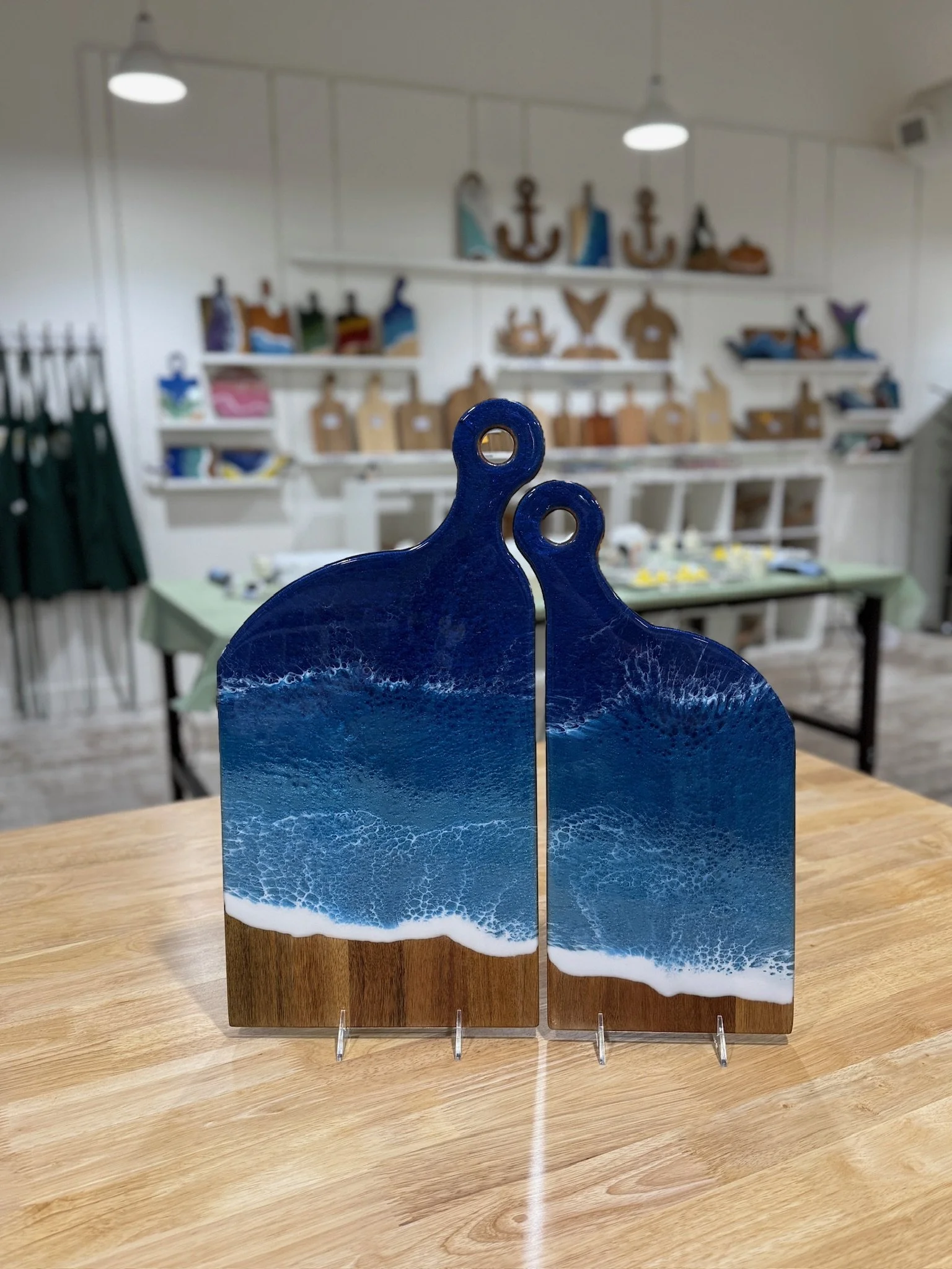 Large Wooden Romeo and Juliet charcuterie board with resin ocean wave poured on it.