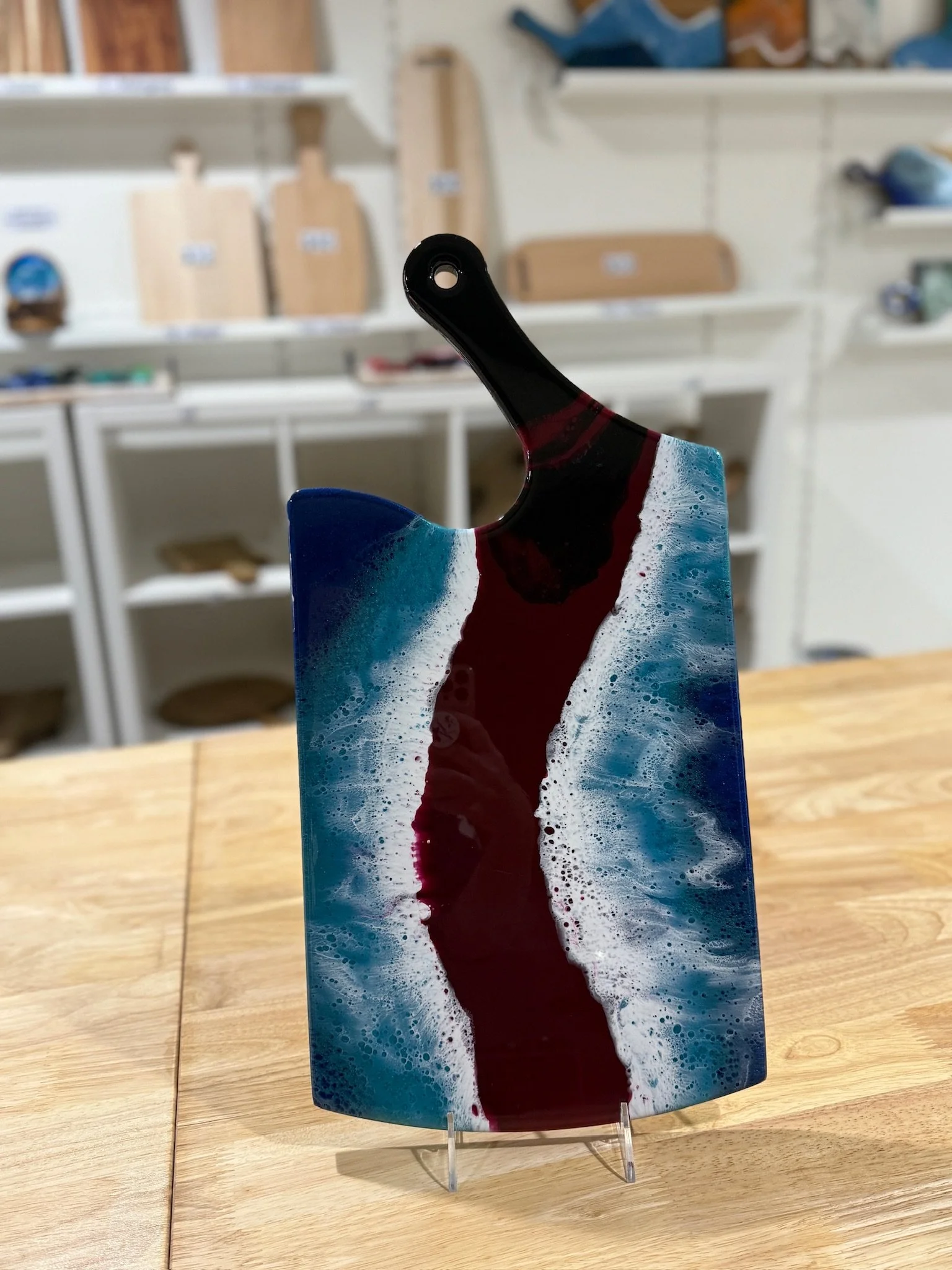 Large Wooden charcuterie board with resin ocean wave poured on it.