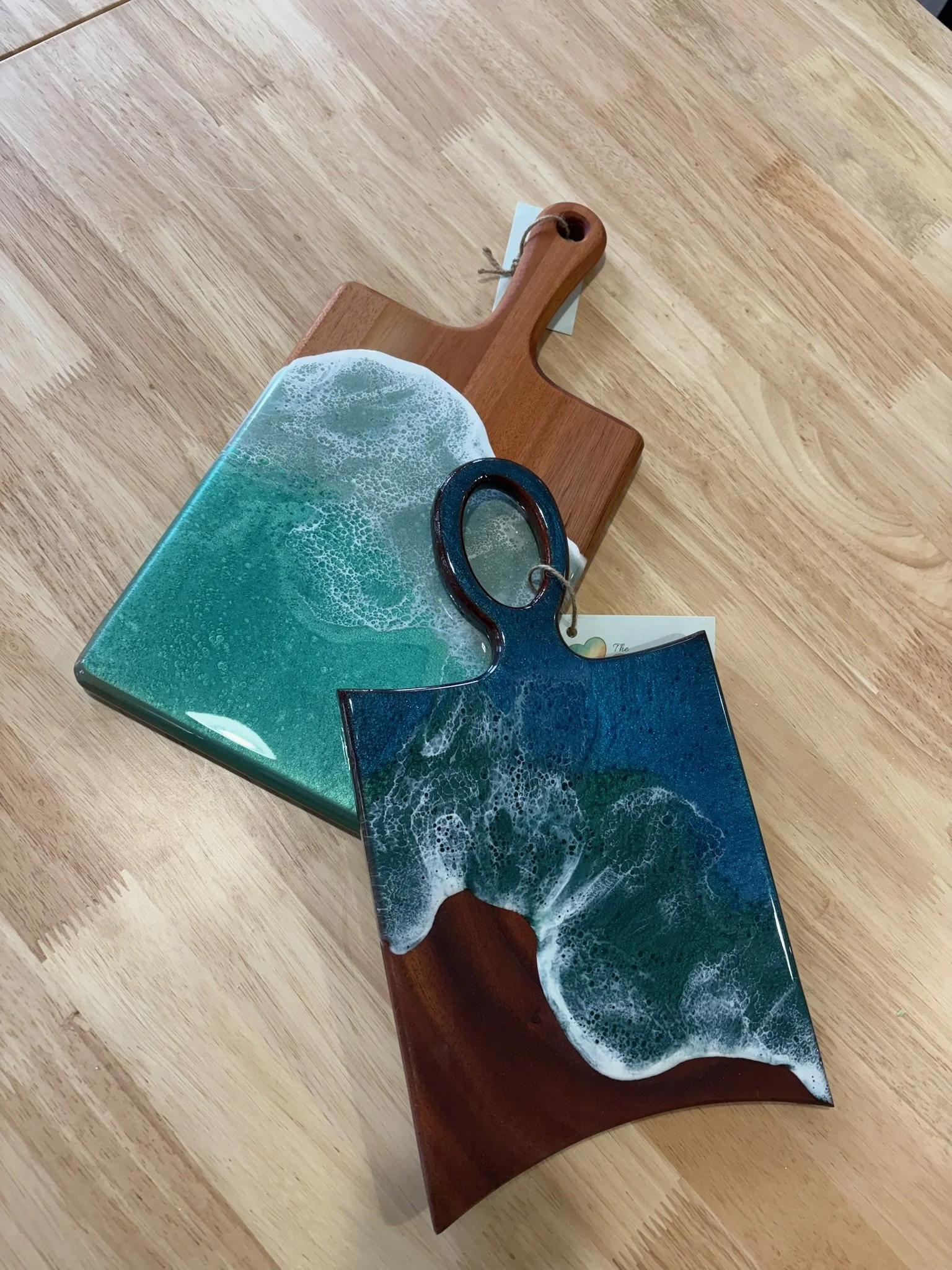 Wooden charcuterie board with resin ocean wave poured on it.