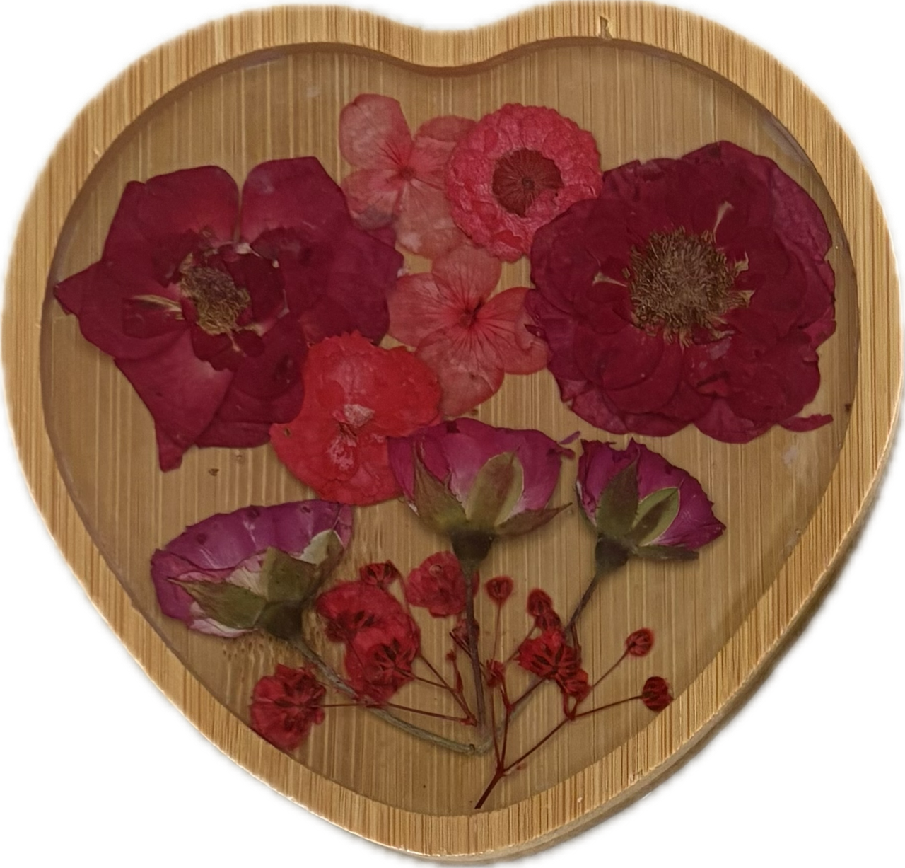 Resin flower wooden coaster. A heart-shaped wooden box filled with dried pink and red flower petals and small flower buds.