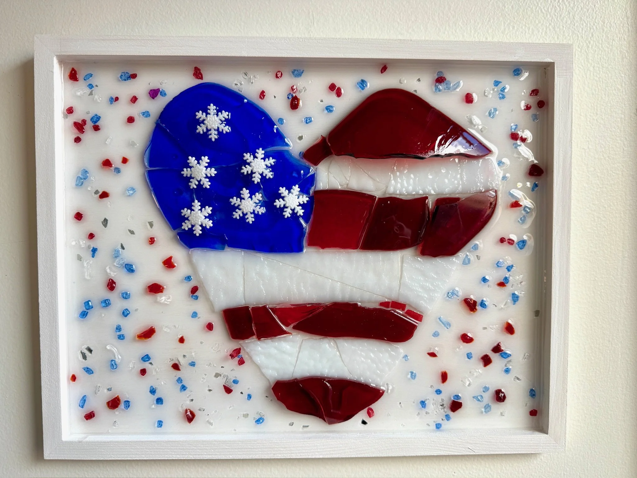 Resin Glass Art of a red, white, and blue patriotic heart using cut and crushed glass in a painted frame.