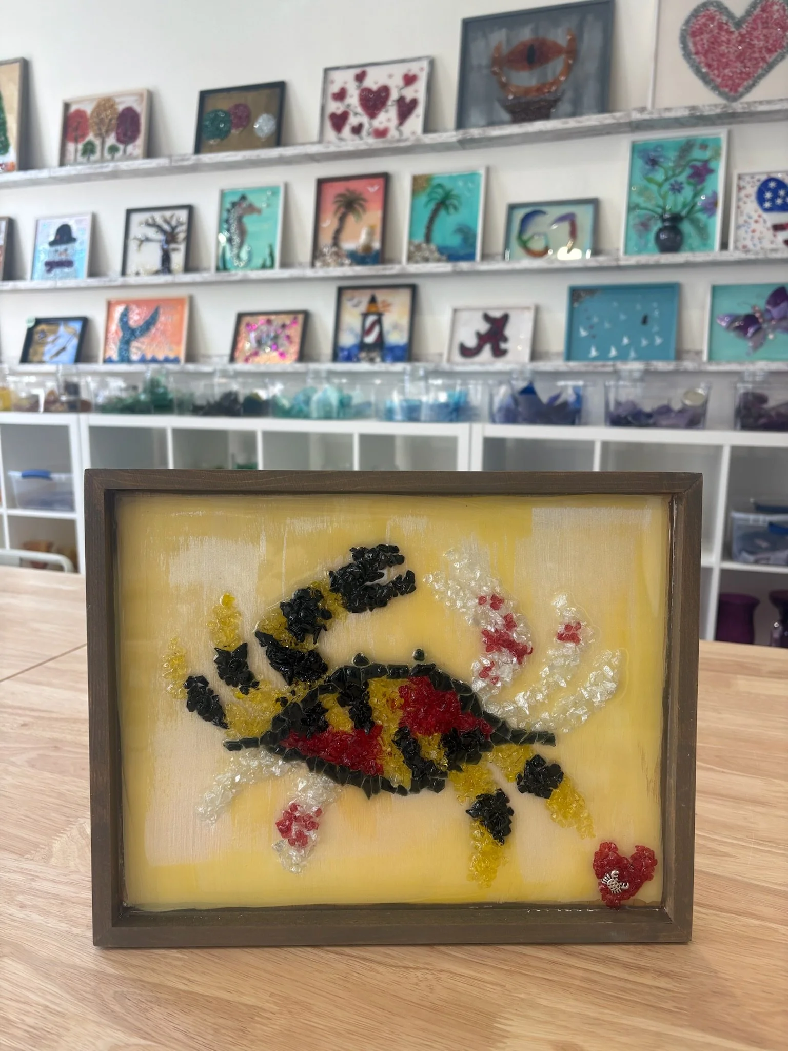 Resin Glass Art of a crab using cut and crushed glass in a painted frame.