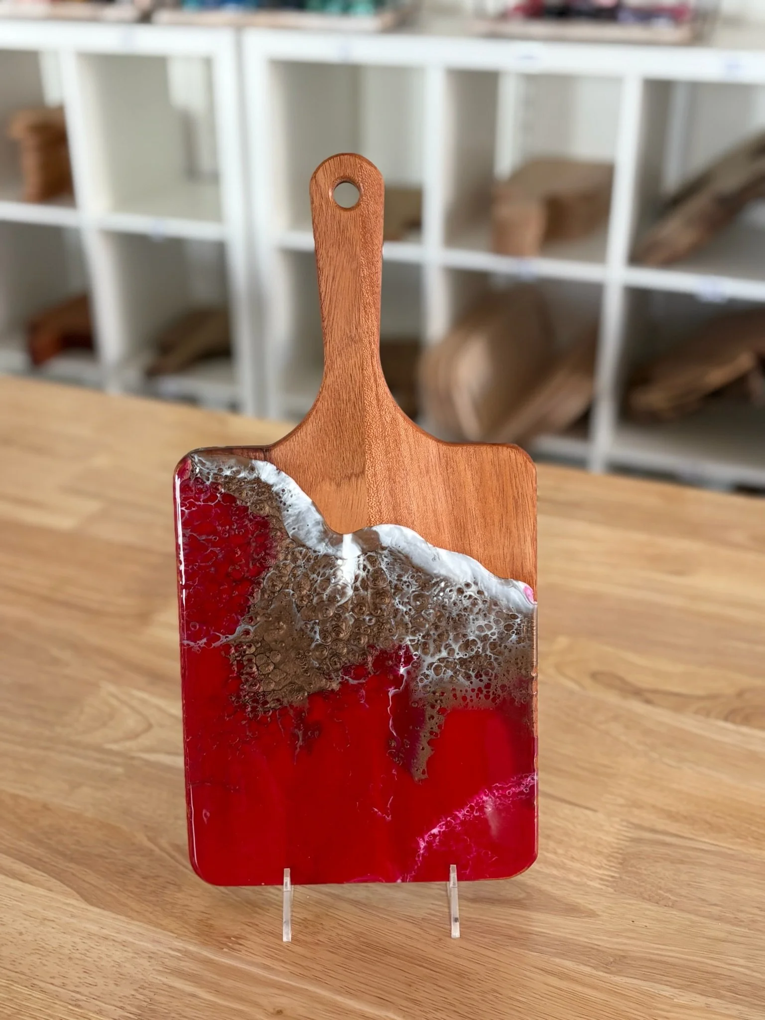 Wooden charcuterie board with resin ocean wave poured on it.