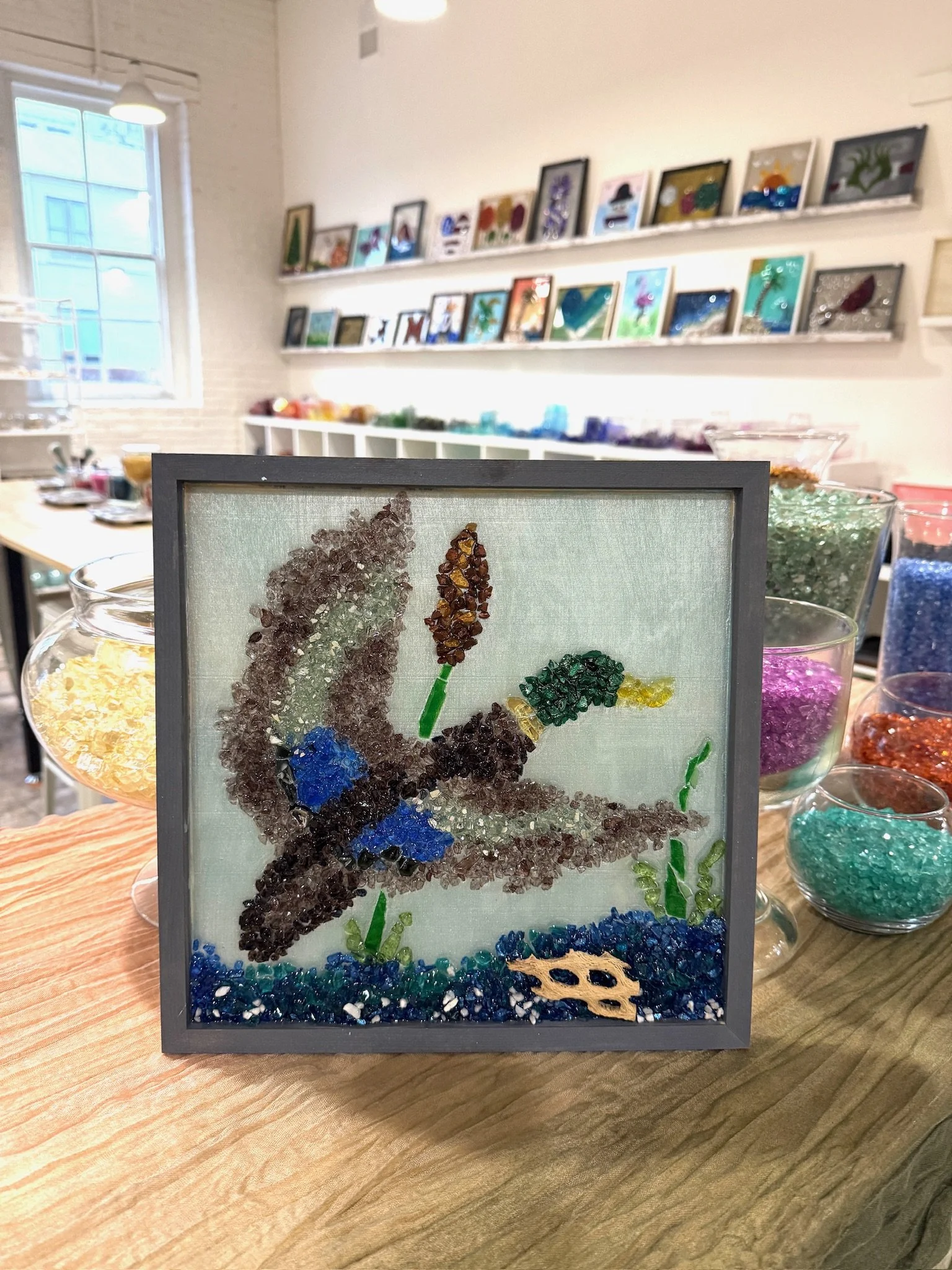 Resin Glass Art of a duck (mallard) using cut and crushed glass in a painted frame.
