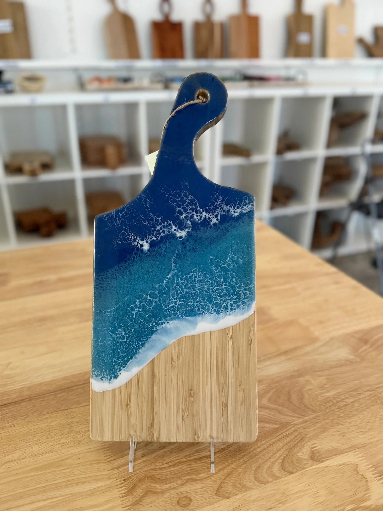 Wooden charcuterie board with resin ocean wave poured on it. 