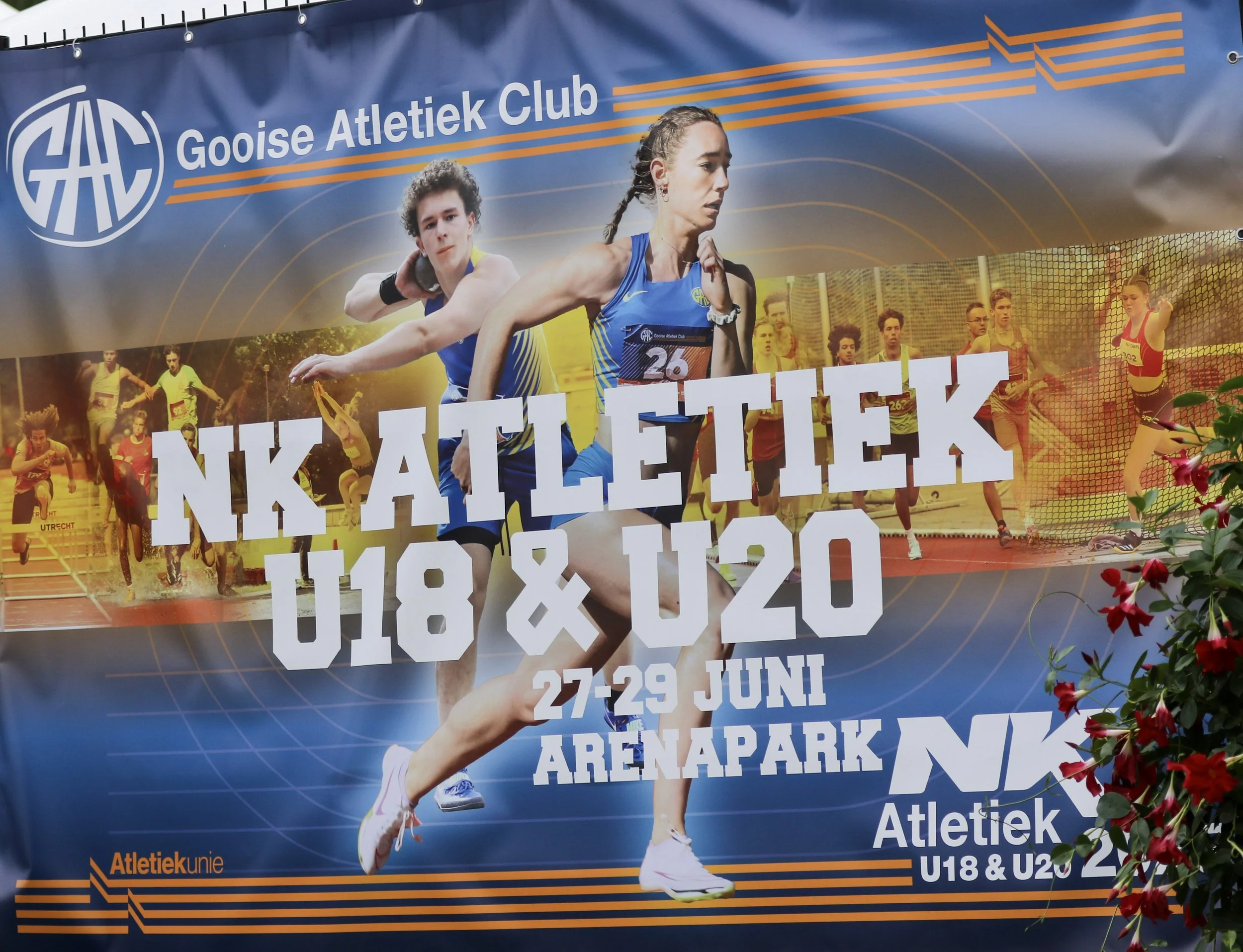 A promotional poster for an athletic event by GOOISE ATLETIEK CLUB, featuring athletes running and jumping, with details about the event on June 27-29 at ArenaPark, for U18 and U20 categories.