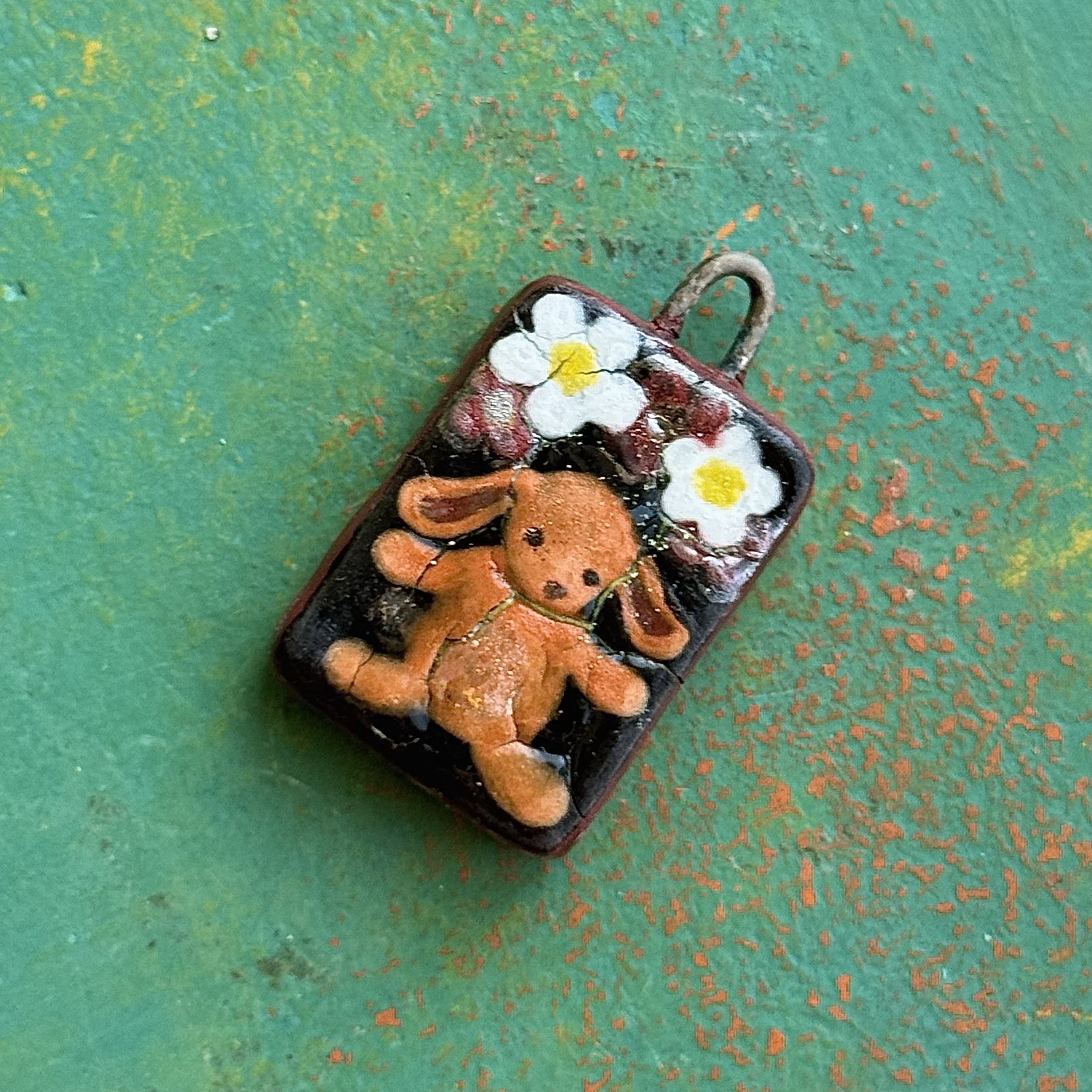 "DOLLS WILL BE DOLLS" (back), red earth ceramic pendant, velvet underglaze, white gold/mother of pearl lustre