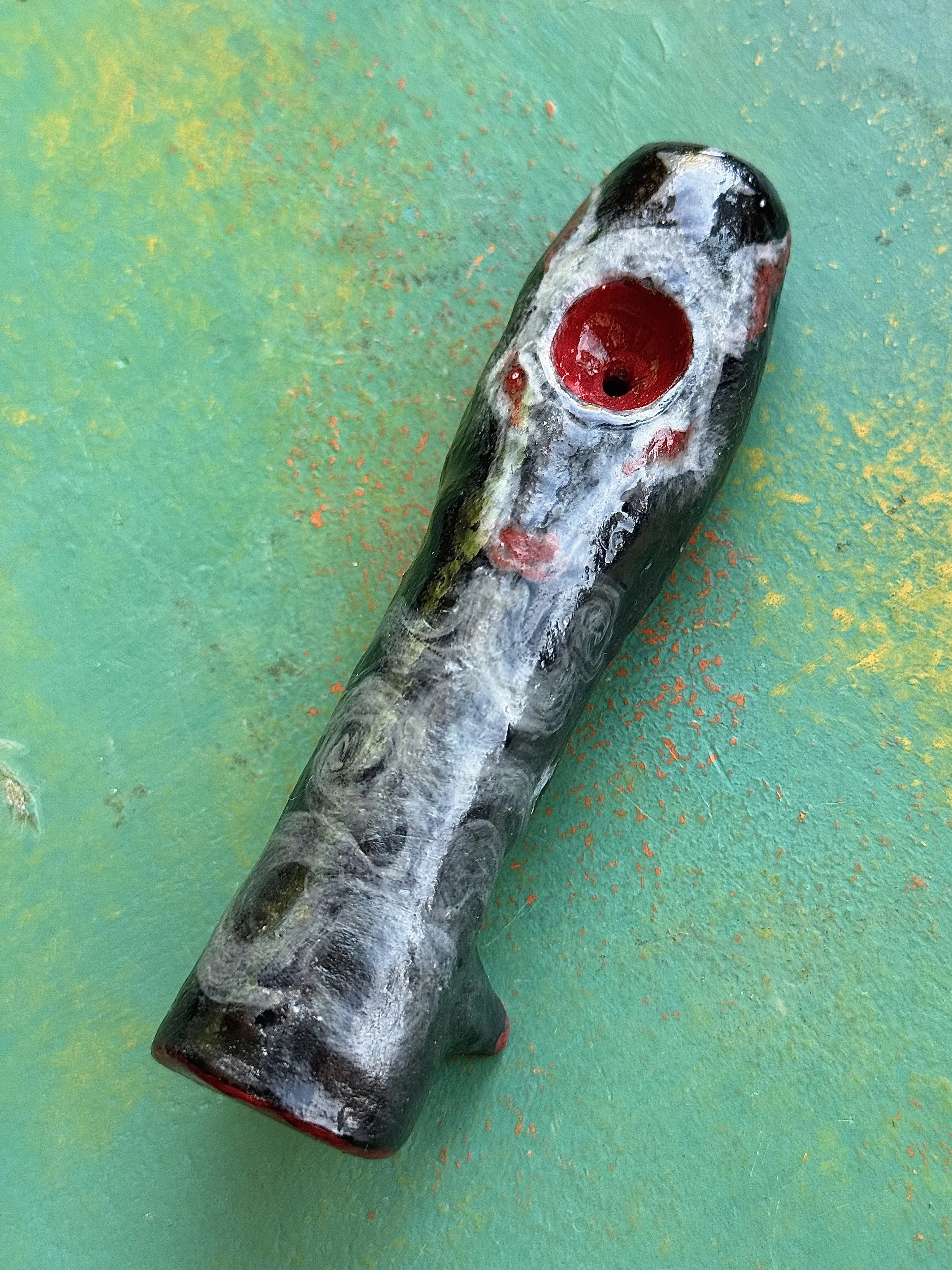 "Where wind blows and wolves bellow." red earth ceramic pipe, velvet underglaze, mother of pearl lustre