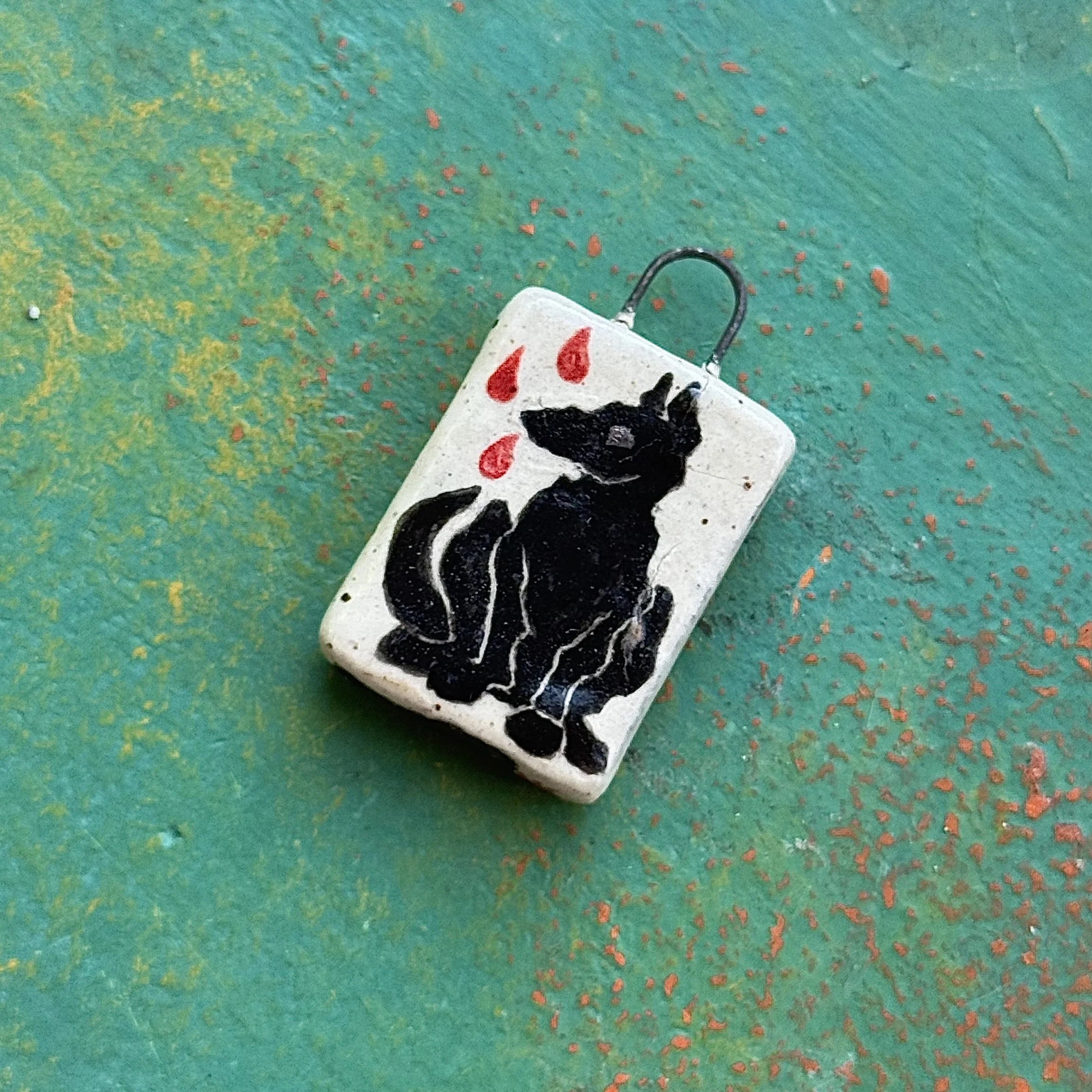 "BARK FULL OF BITE", red earth ceramic pendant, velvet underglaze, white gold lustre