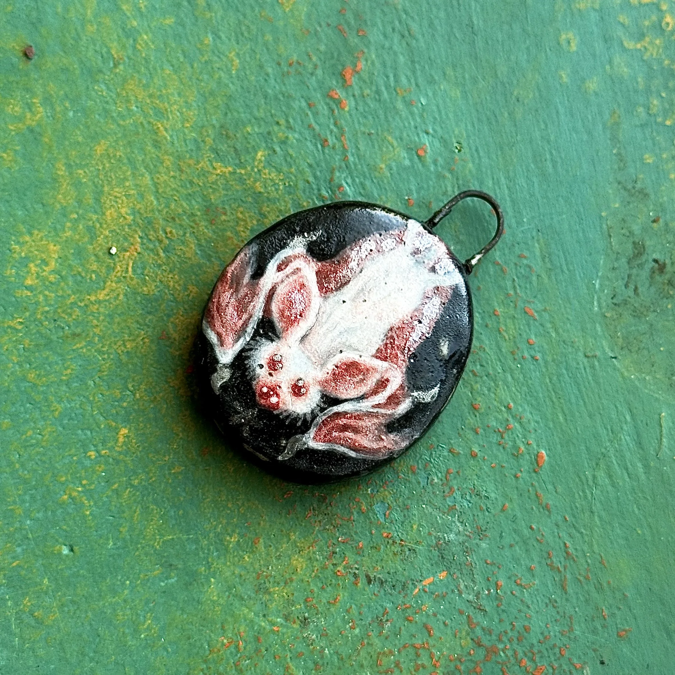 "ALBINO BAT", red earth ceramic pendant, velvet underglaze, white gold/mother of pearl lustre