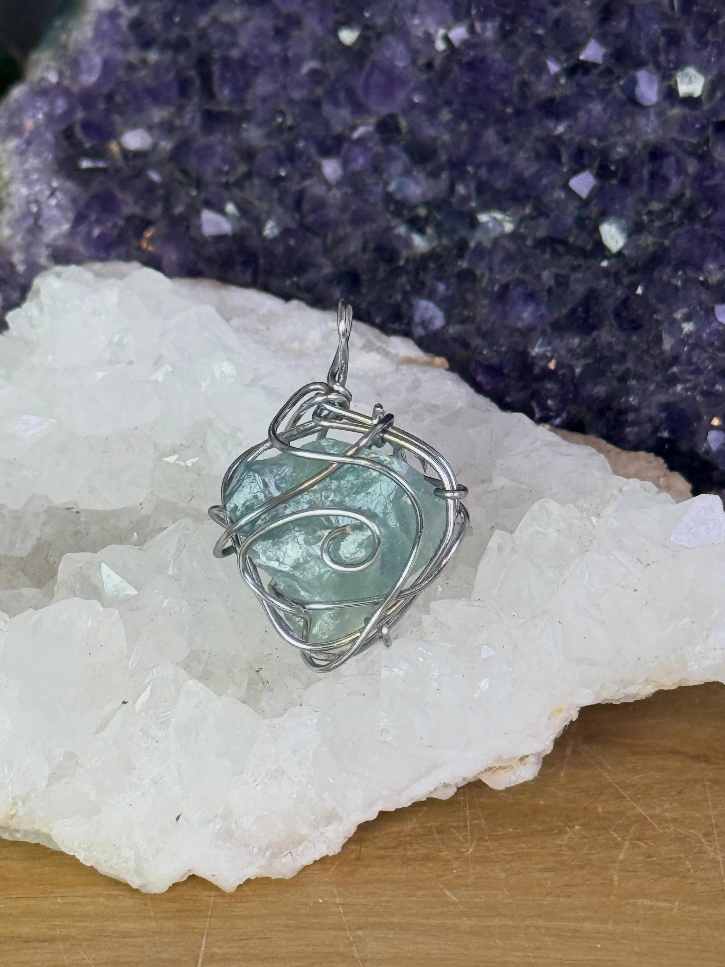 These photos do not do this piece of raw rainbow fluorite justice! It is gorgeous in the light ☺️ had to wrap it simply so the crystal remained the star of the show!