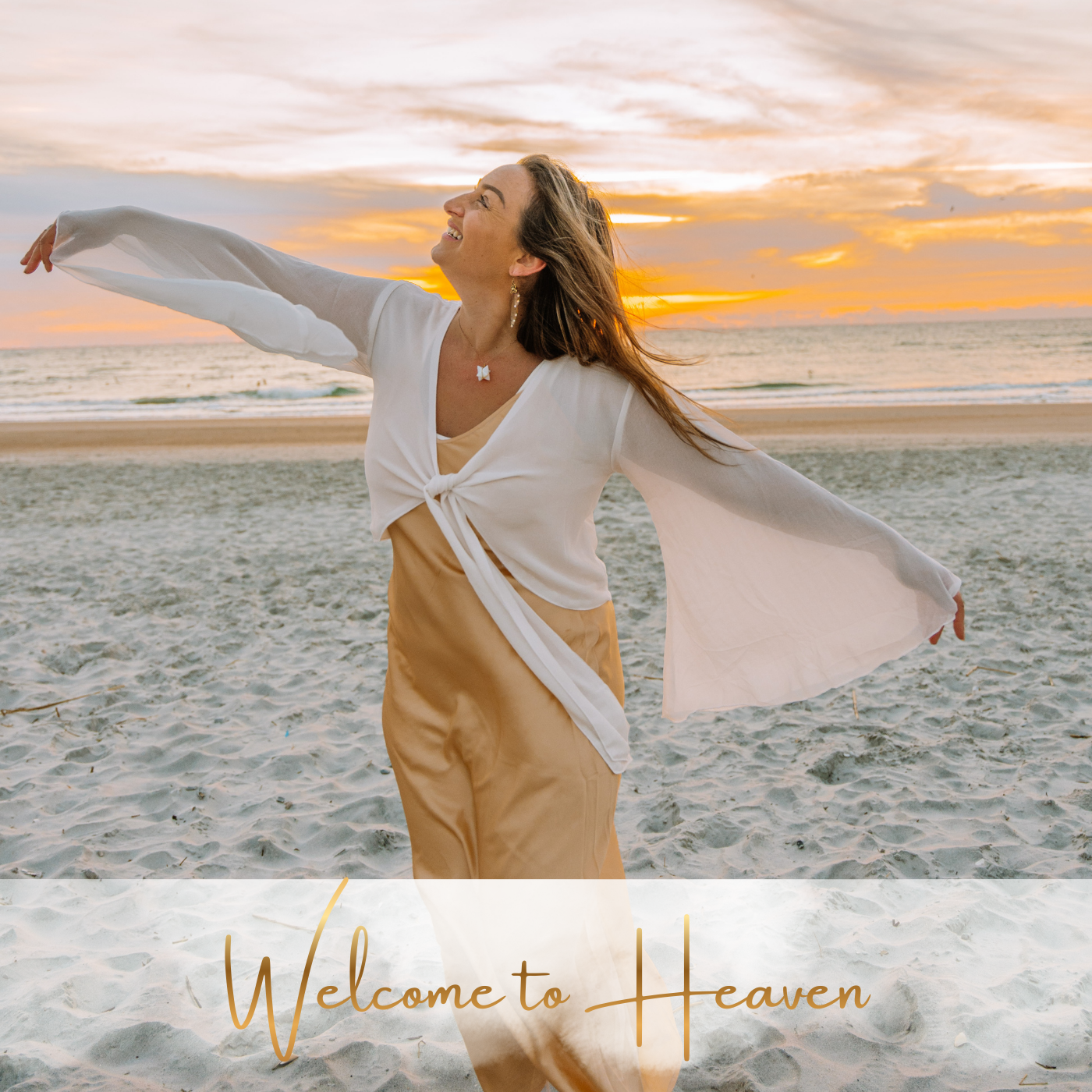 A woman standing on the beach at sunset, smiling with arms outstretched, wearing a white top and tan pants, with the words 'Welcome to Heaven' overlaid at the bottom.