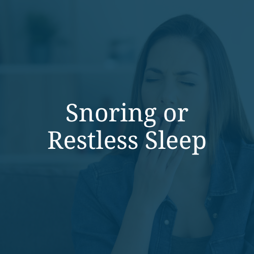 A woman with eyes closed, covering a yawn with her hand, with overlay text that reads 'Snoring or Restless Sleep'