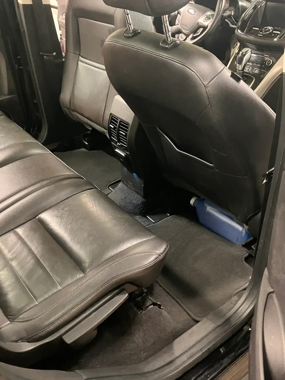 Black leather seats and floor mats cleaned after mobile interior detailing in DC