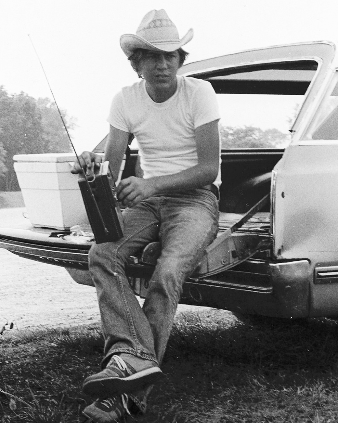 Gary's father Arliss, sitting on the tailgate of their Oldsmobile Vista Cruiser with a cooler full of Budweiser and a fresh pack of Marlboro Reds. He's watching Gary fish in a cove at Old Hickory Lake in 1975. 