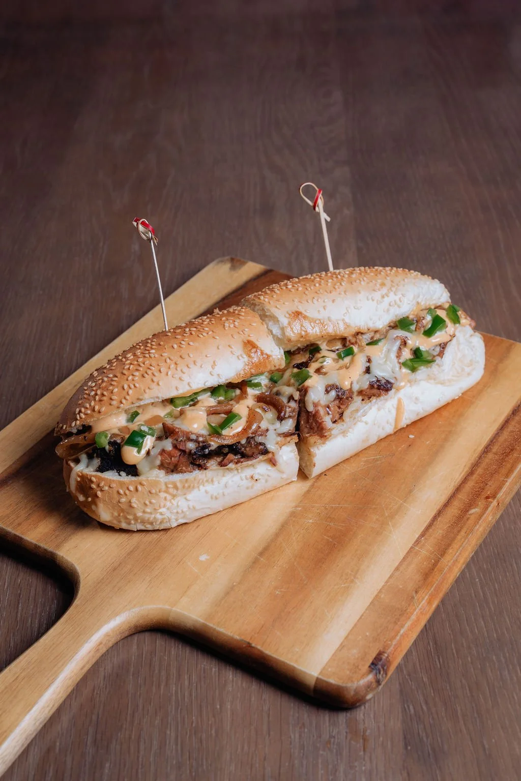 The ultimate smokehouse twist on a Sandwich classic: Our Smoked Brisket Cheese. We pile tender, slow-smoked brisket onto a toasted roll, blanketed in creamy, melting mozzarella cheese. It's topped with deeply caramelized onions, a kick of diced jalap