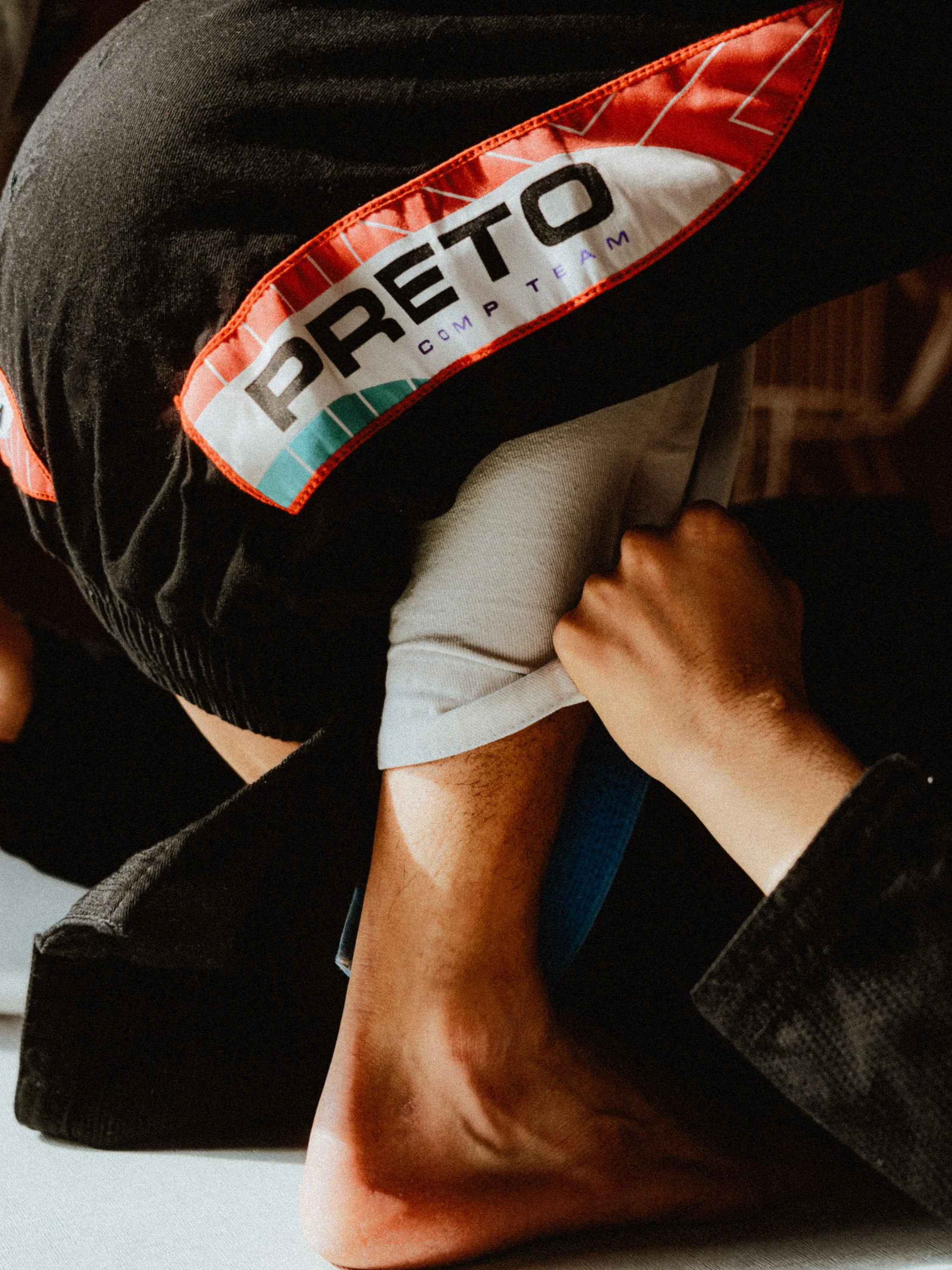 Person performing an armbar submission hold in a martial arts or Brazilian jiu-jitsu competition. Personal Branding Photography and Headshots in London.