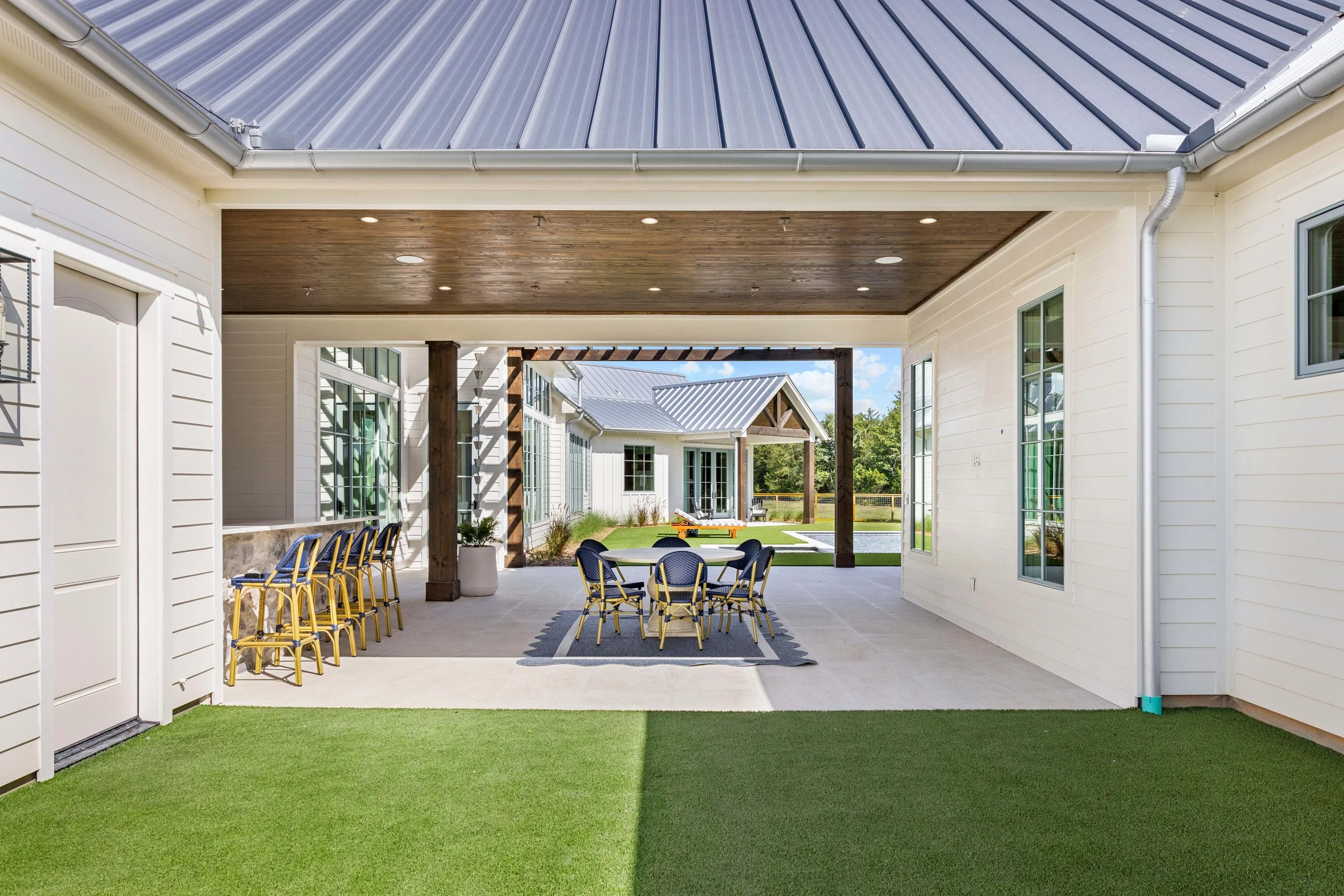 Skycrafted Imaging_Real Estate Media Production_Central & Southeast Texas_Covered outdoor patio area with chairs around a table.