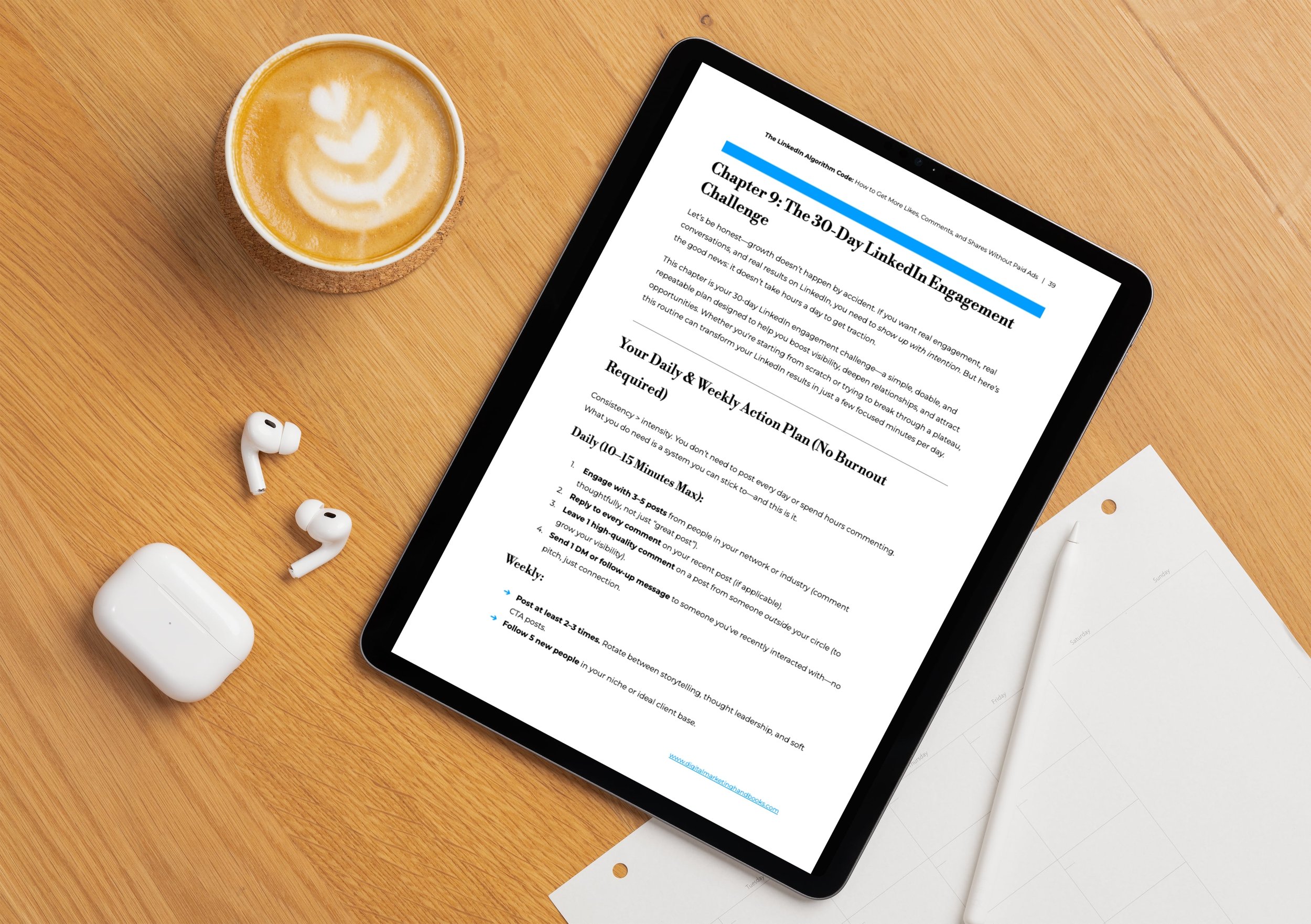 Tablet on a wooden desk displaying a document titled 'Chapter 9: The 30-Day LinkedIn Engagement Challenge,' with a latte with latte art and wireless earbuds nearby.