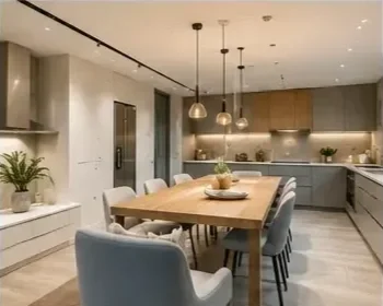 Modern kitchen and dining area with wooden table, six chairs, pendant lighting, and kitchen cabinets.