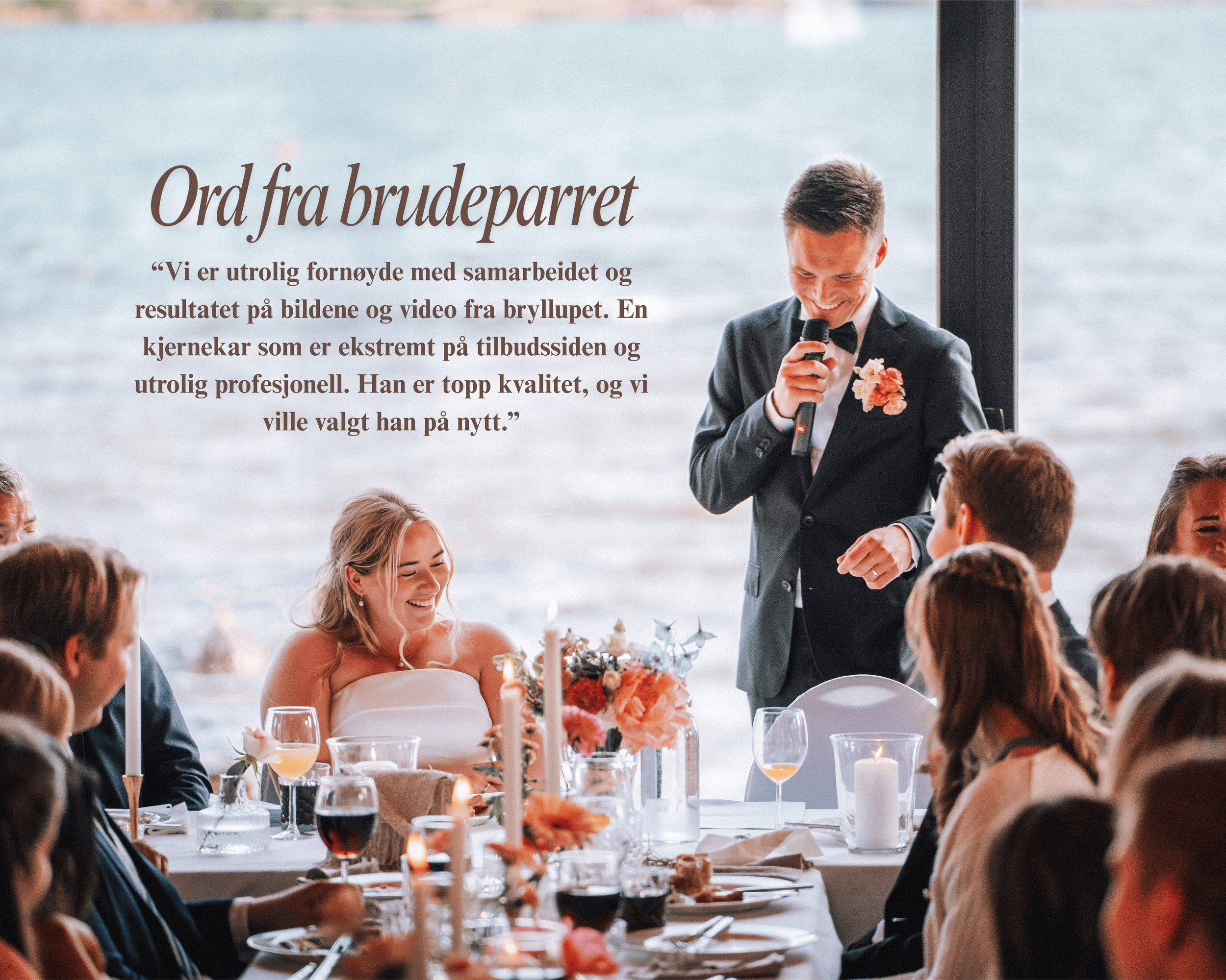 A man in a black tuxedo giving a speech at a wedding reception, with the bride and guests sitting at a decorated table with candles and flowers by the water.
