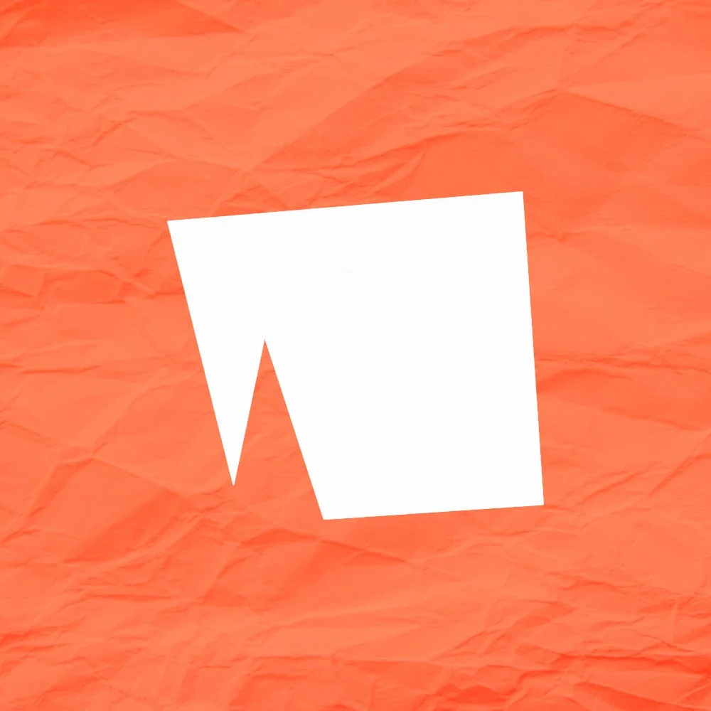 A white geometric abstract shape on crumpled orange paper.