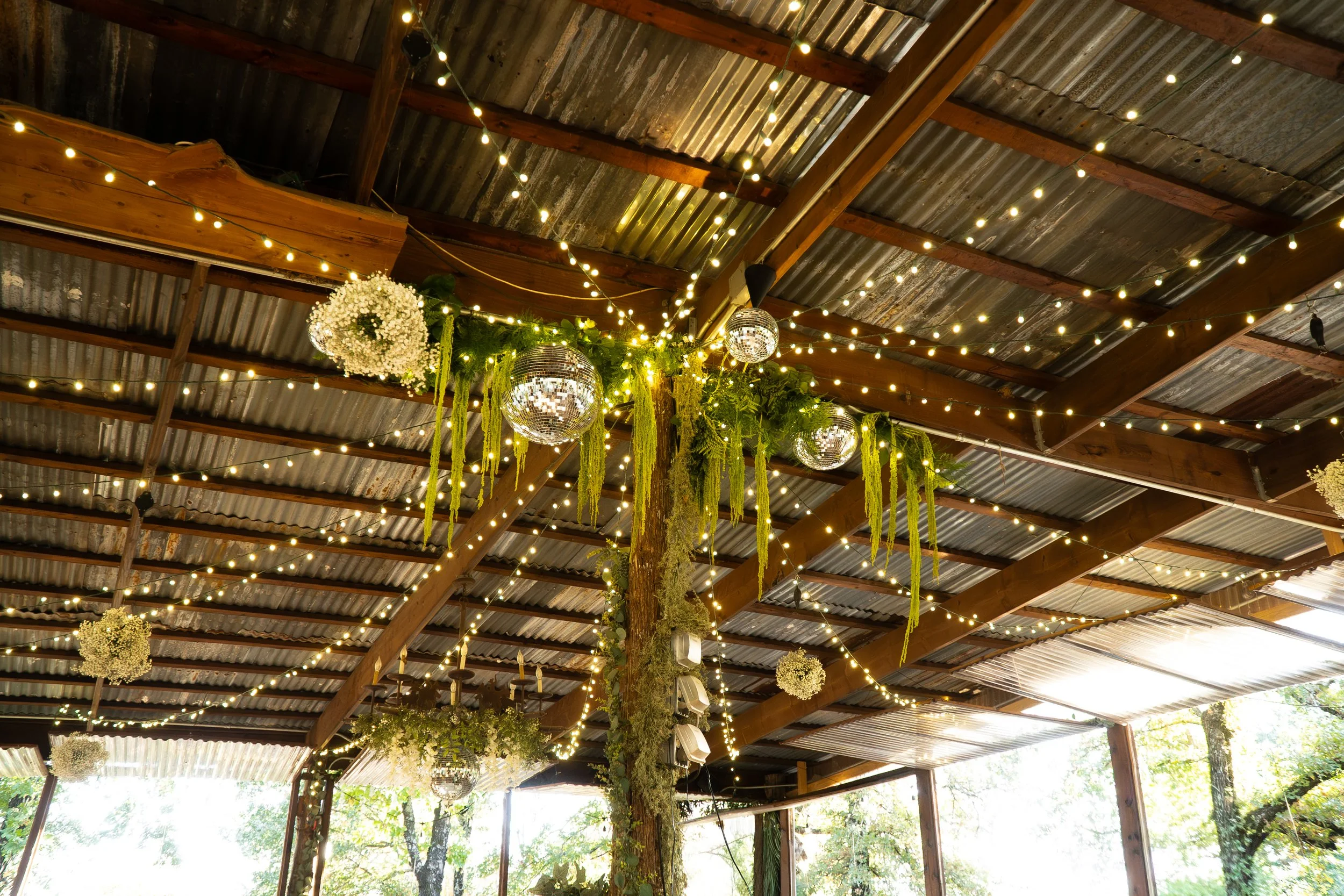 hanging fresh floral arrangements with disco balls and baby's breath