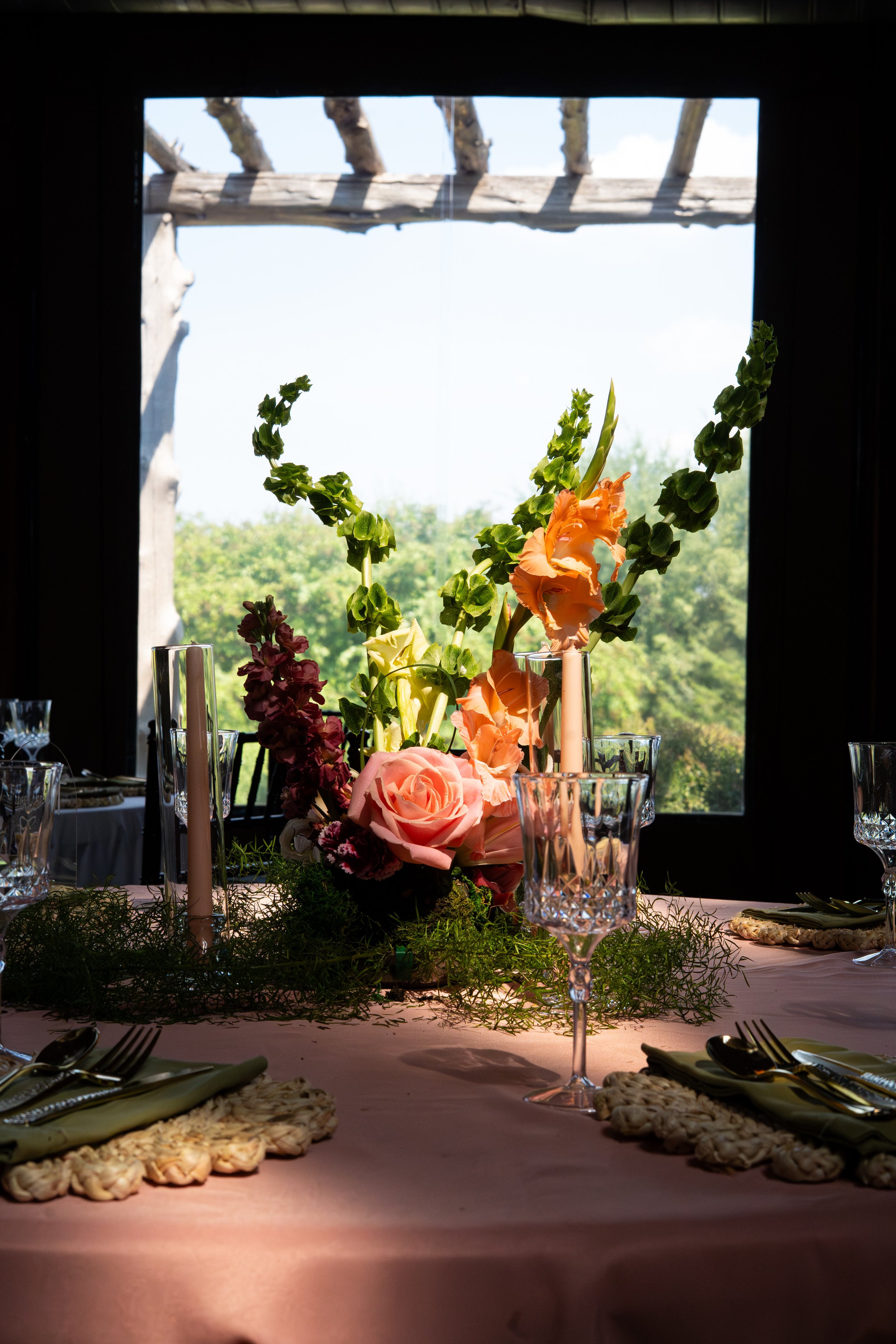 bells of Ireland, roses, wedding table decor, pink tablecloth