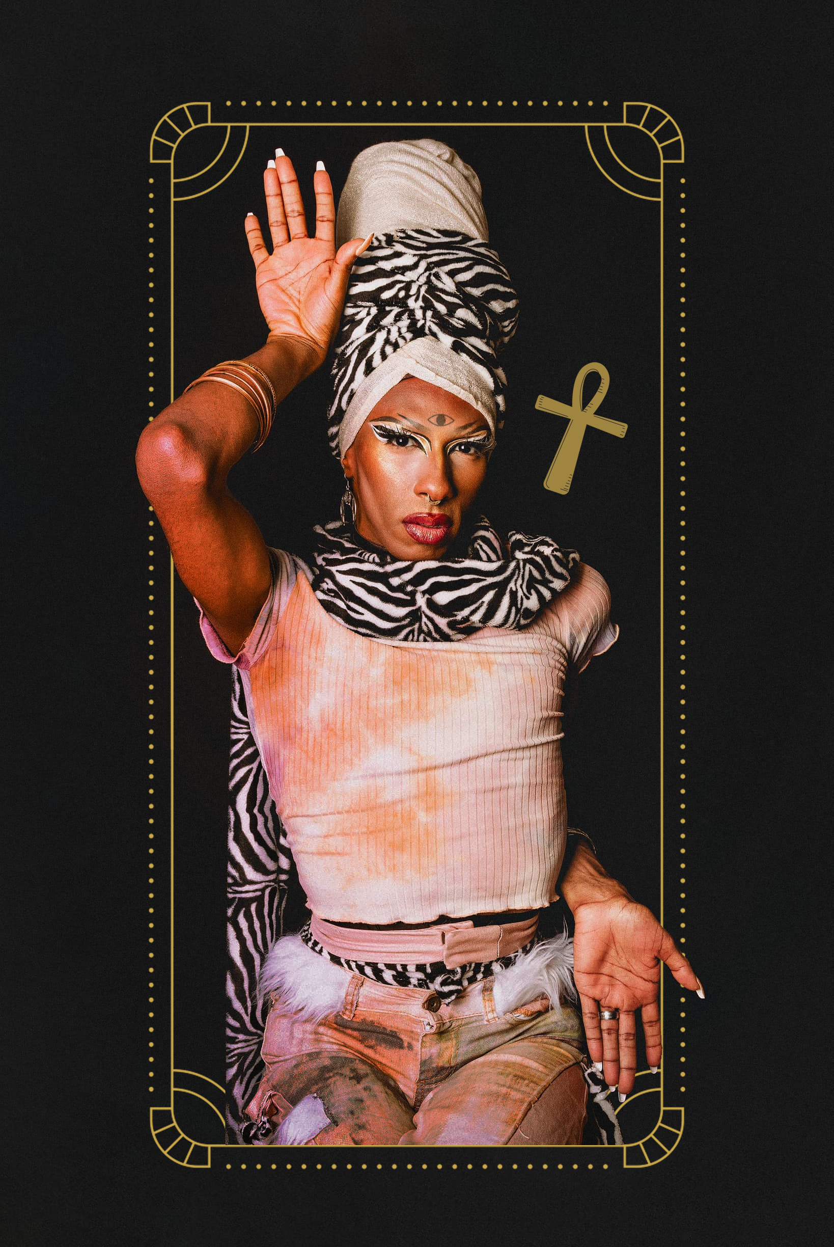 A woman dressed in a colorful, eclectic outfit with animal print accessories, wearing a large wrapped headscarf, bold makeup, and jewelry, striking a pose against a black background with gold decorative elements and a cross symbol.