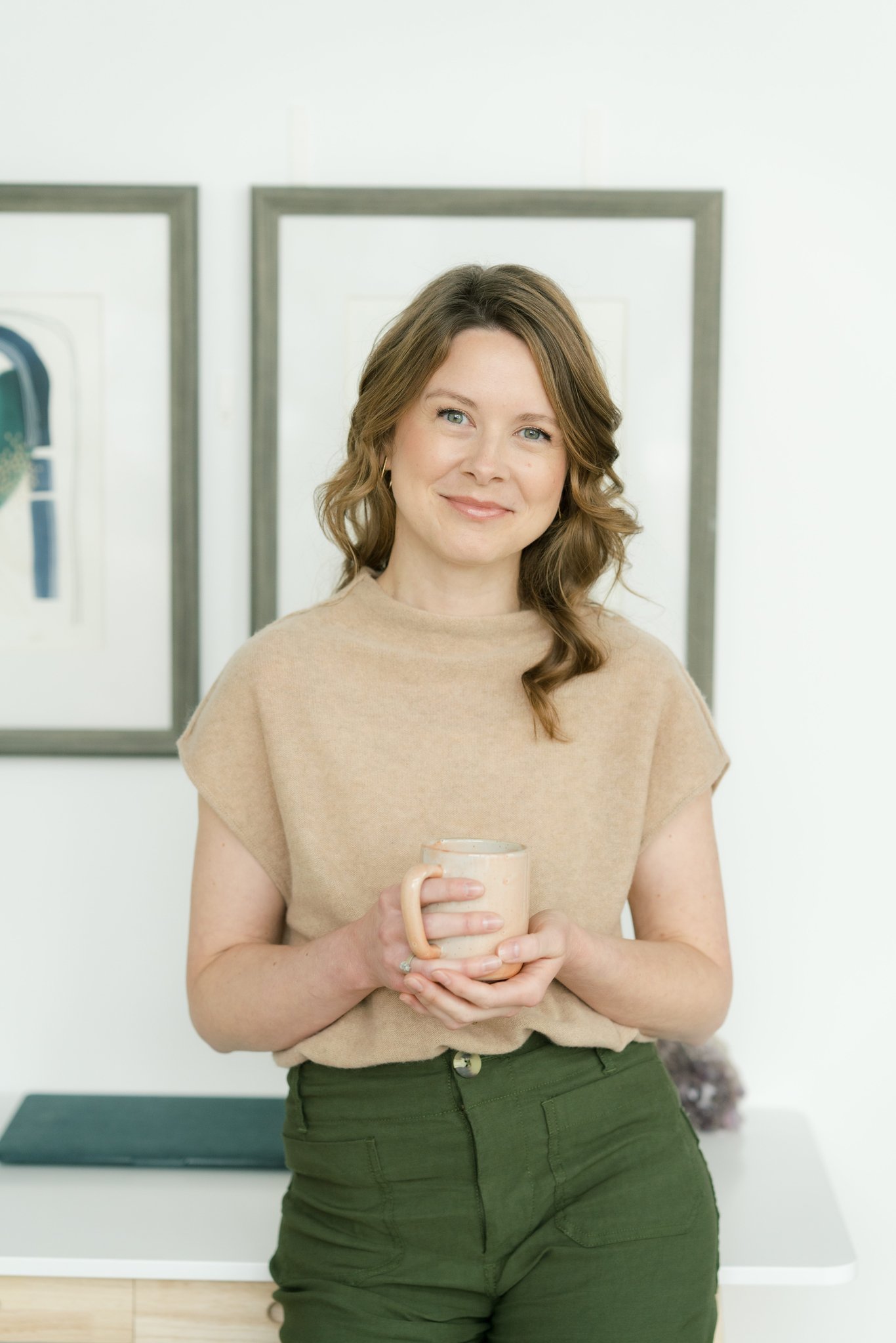 Tishna Rollo, LPC, holding a mug.