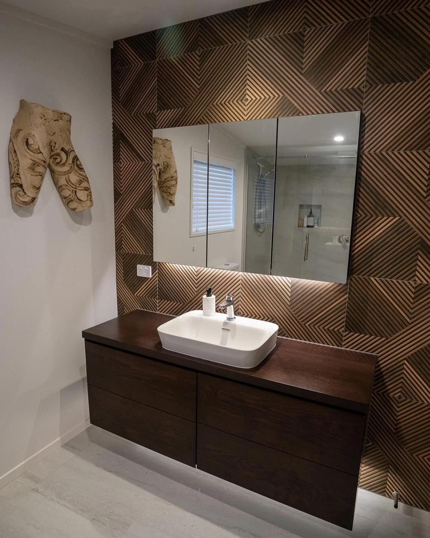 Modern bathroom renovation with custom timber vanity and geometric feature wall by Capital G Construction and CGC Property Solutions in Tauranga