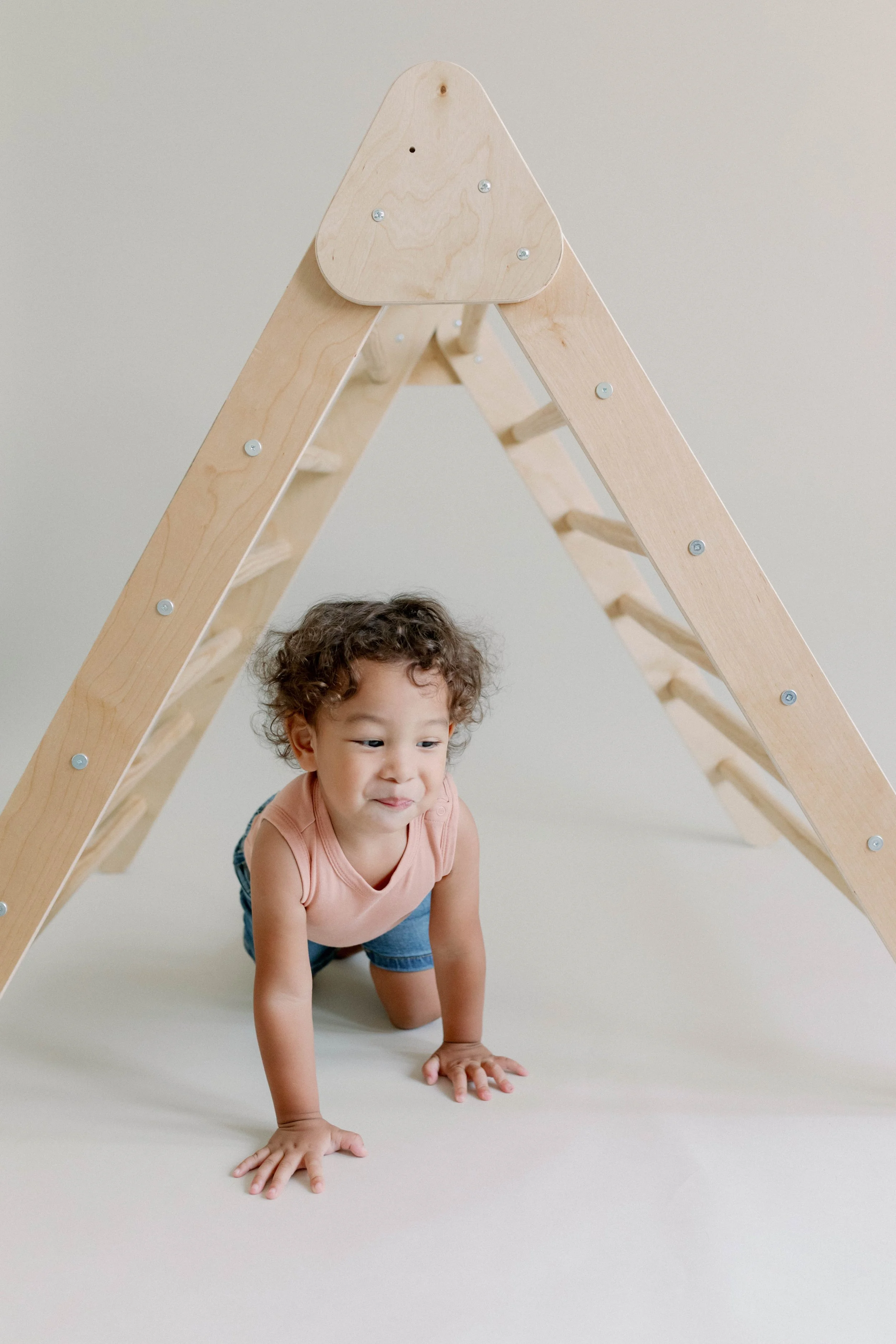 Natural, Montessori-inspired wooden toy ladder by Calmatco, showcasing warm wood tones and clean, functional design.