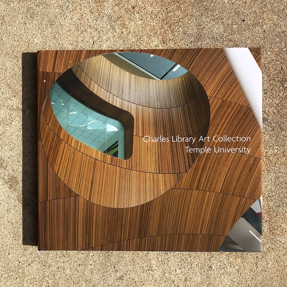 A book cover featuring an interior view of a modern building with curved wooden walls and a skylight, titled 'Charles Library Art Collection Temple University'.
