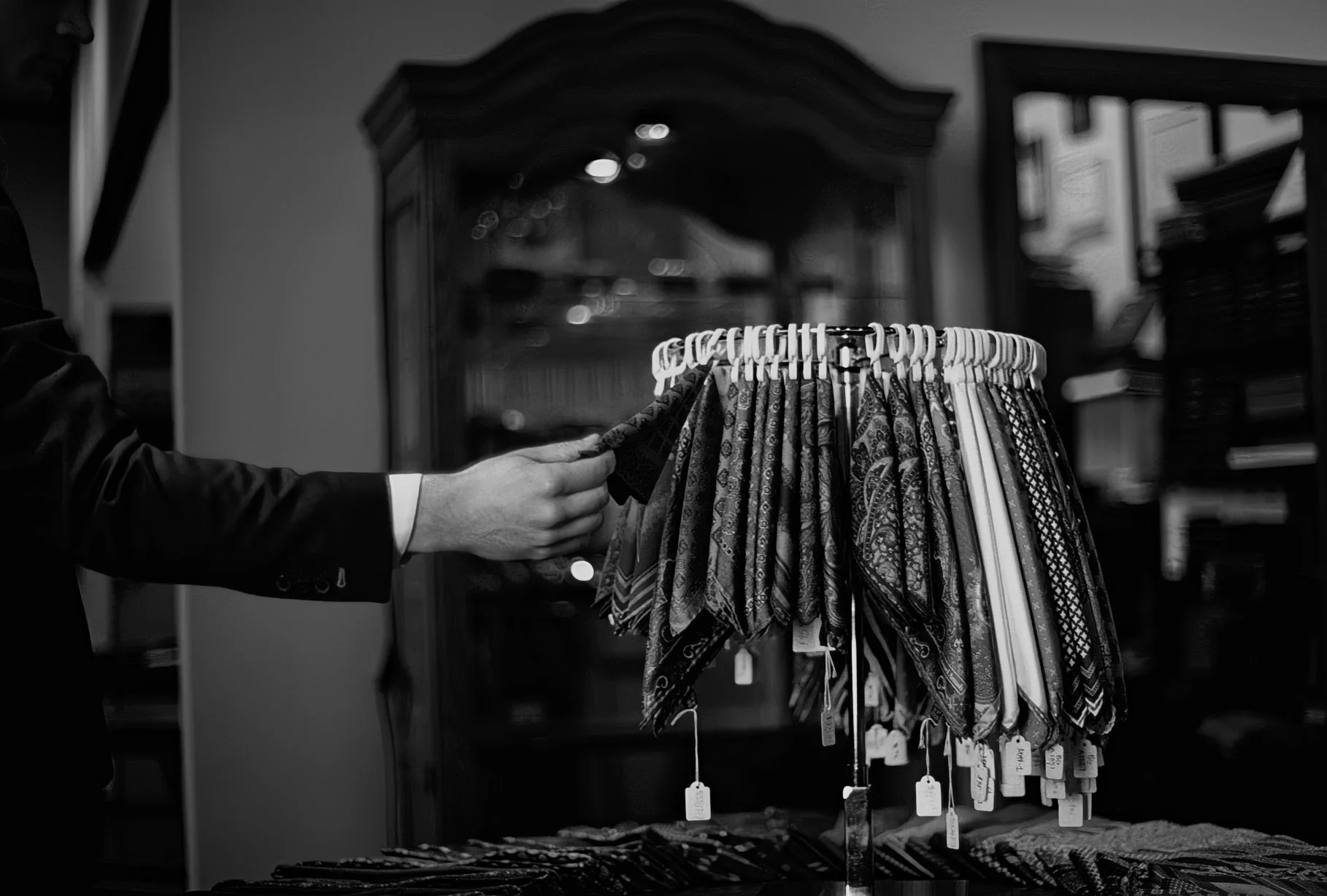 Outstretched hand looking at ties and handkerchiefs. Philadelphia, Henry Davidsen. 