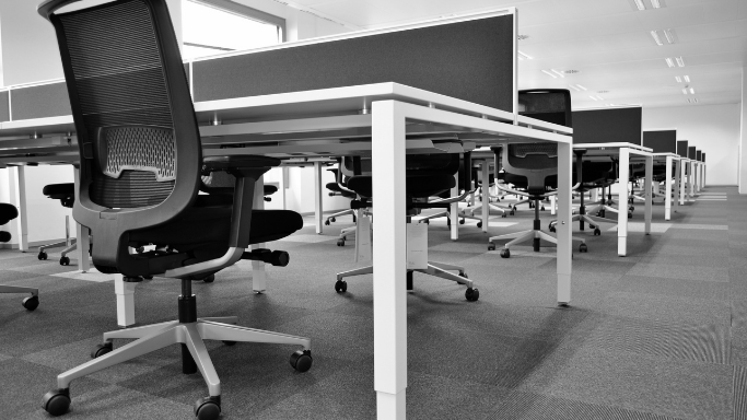 Office full of empty desks and chairs