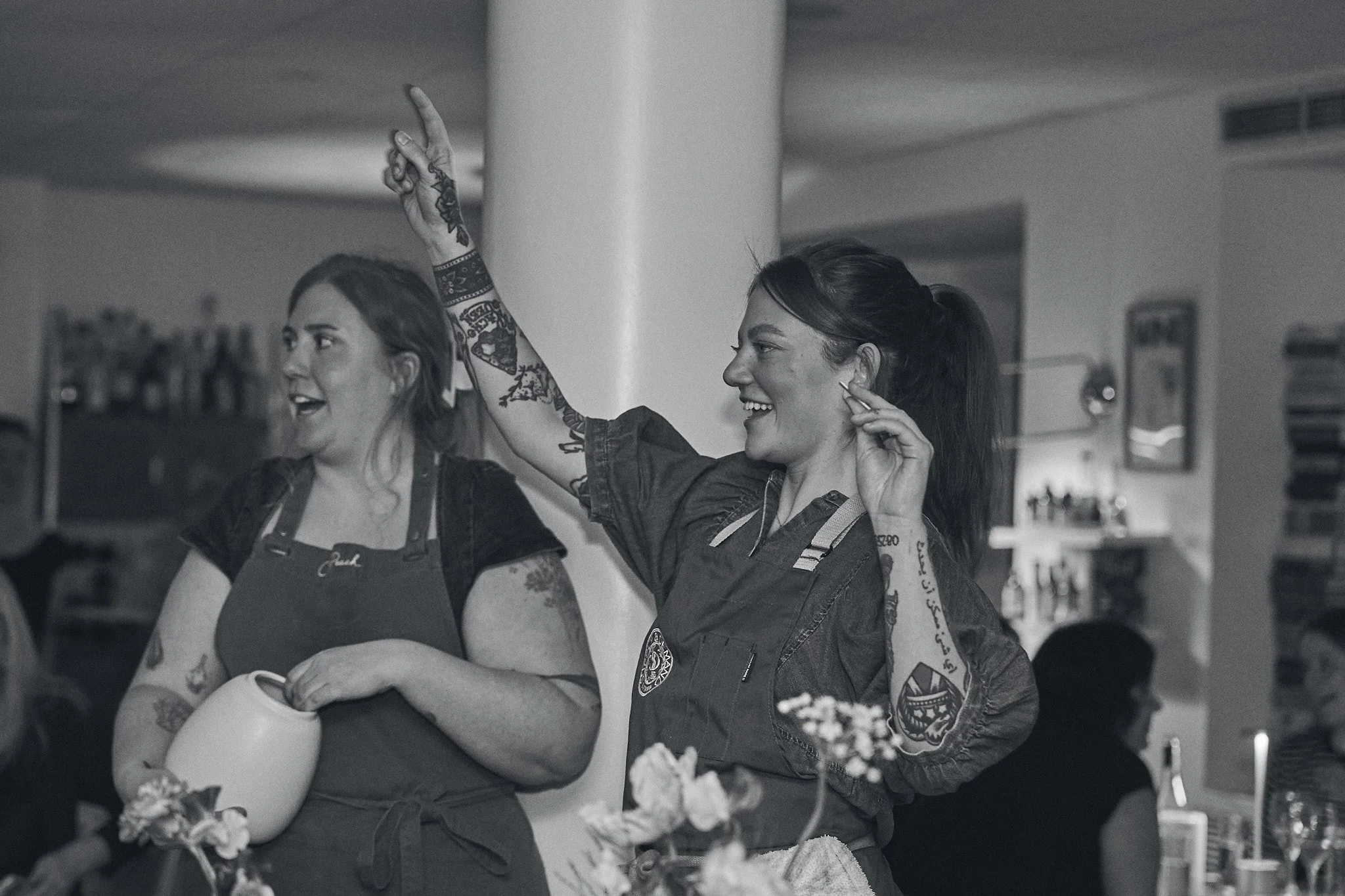 Mélyna Amyot and Kali Fawcett, founders of Girl Dinner speaking in front of a crowd at Girl Dinner. Photographed by Gumption Studio, Ottawa event photographer.