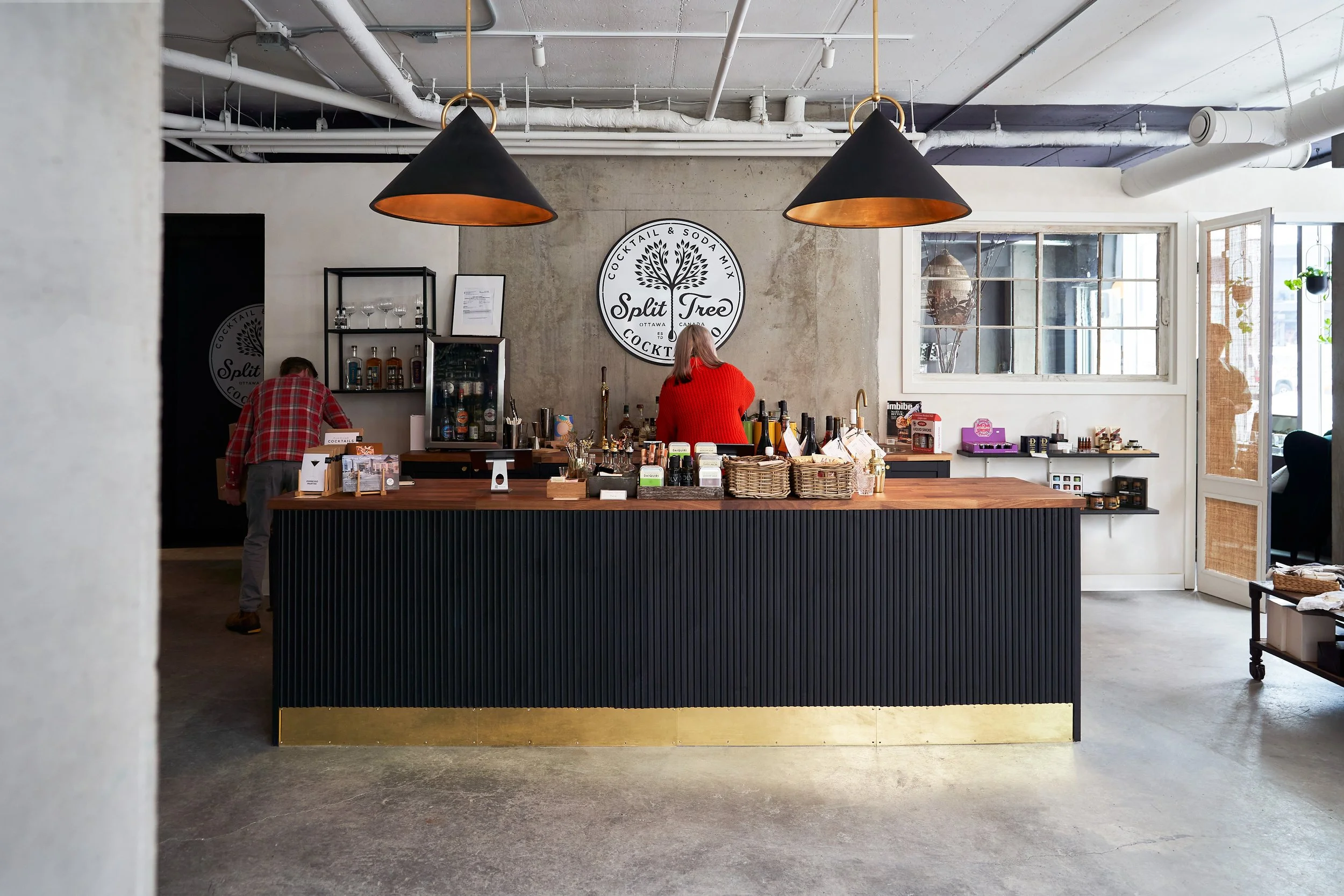 Aryn Pepper and Steve Morrier working behind the counter at Split Tree. Photographed by Gumption Studio, Ottawa cocktail photographer.