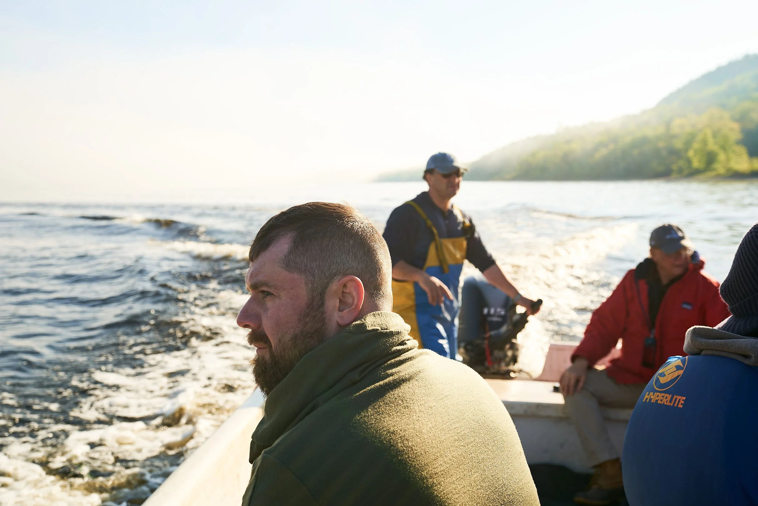 Justin Champagne-Lagarde on a boat at Acadian Sturgeon Caviar doing a Sturgeon Safari. Photographed for the Perch Cookbook by Gumption Studio, Ottawa Cookbook photographer.