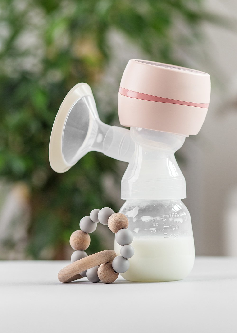 Breast pump and bottle with breast milk, arranged neatly on a counter