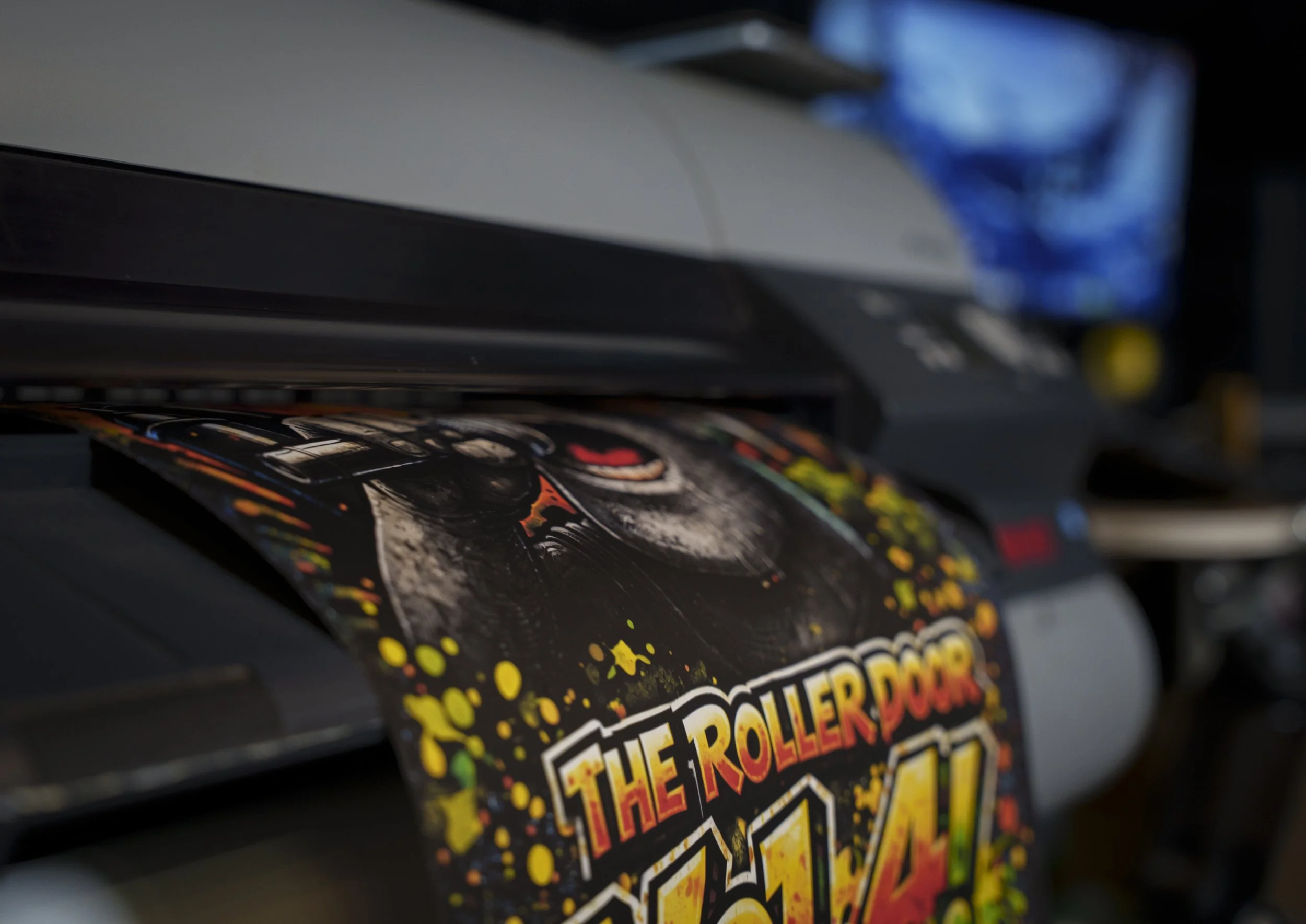 Close-up of an event flyer being printing. lots of vibrant colours