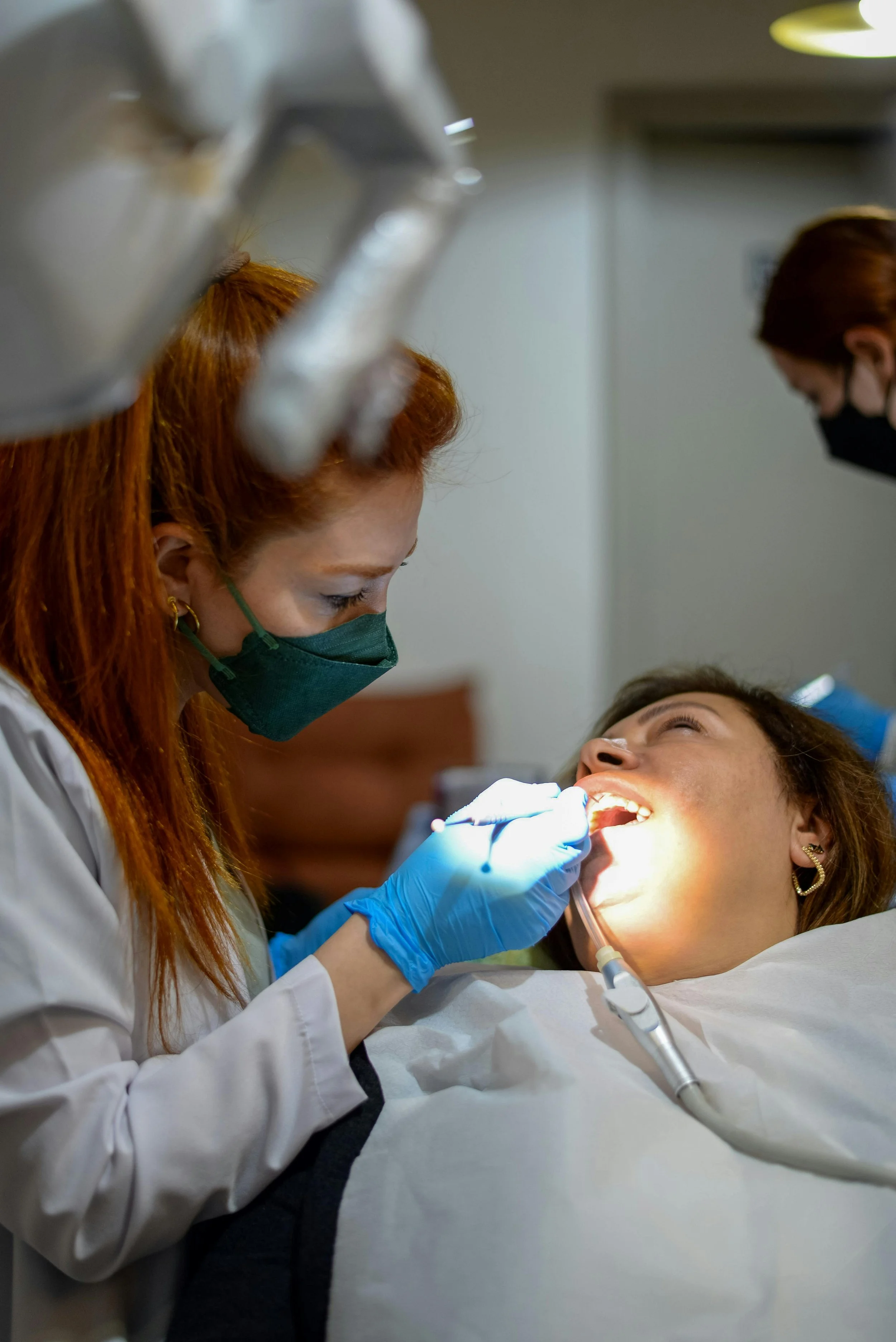 Dentist performing dental procedure on woman