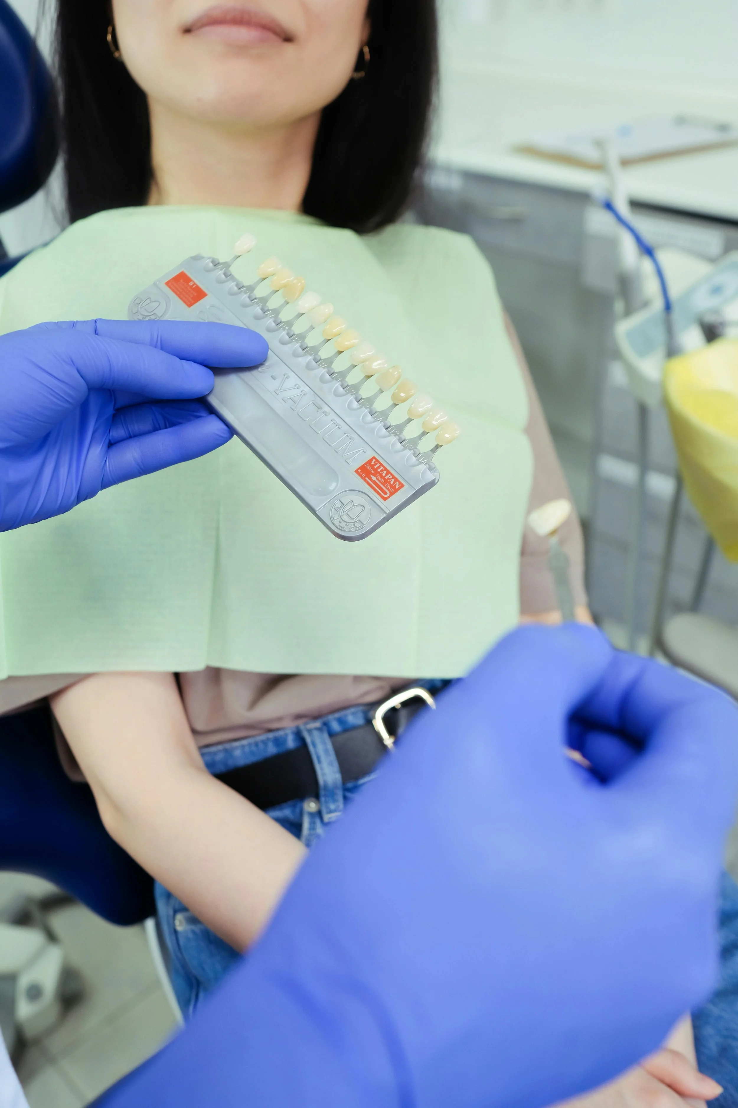 Dentist and patient discussing tooth colour with a colour comparison chart