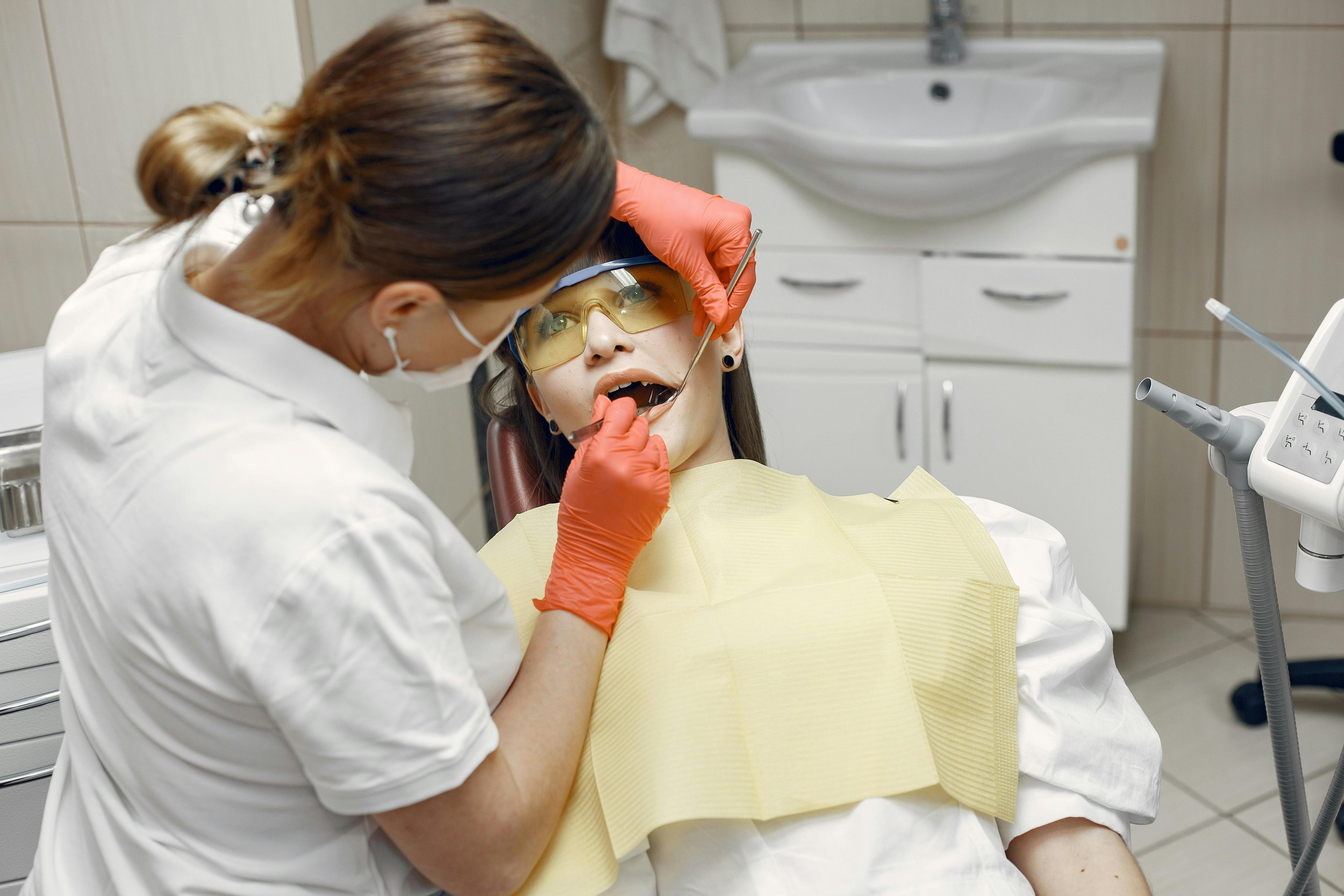 Dentist performing a dental procedure on a woman