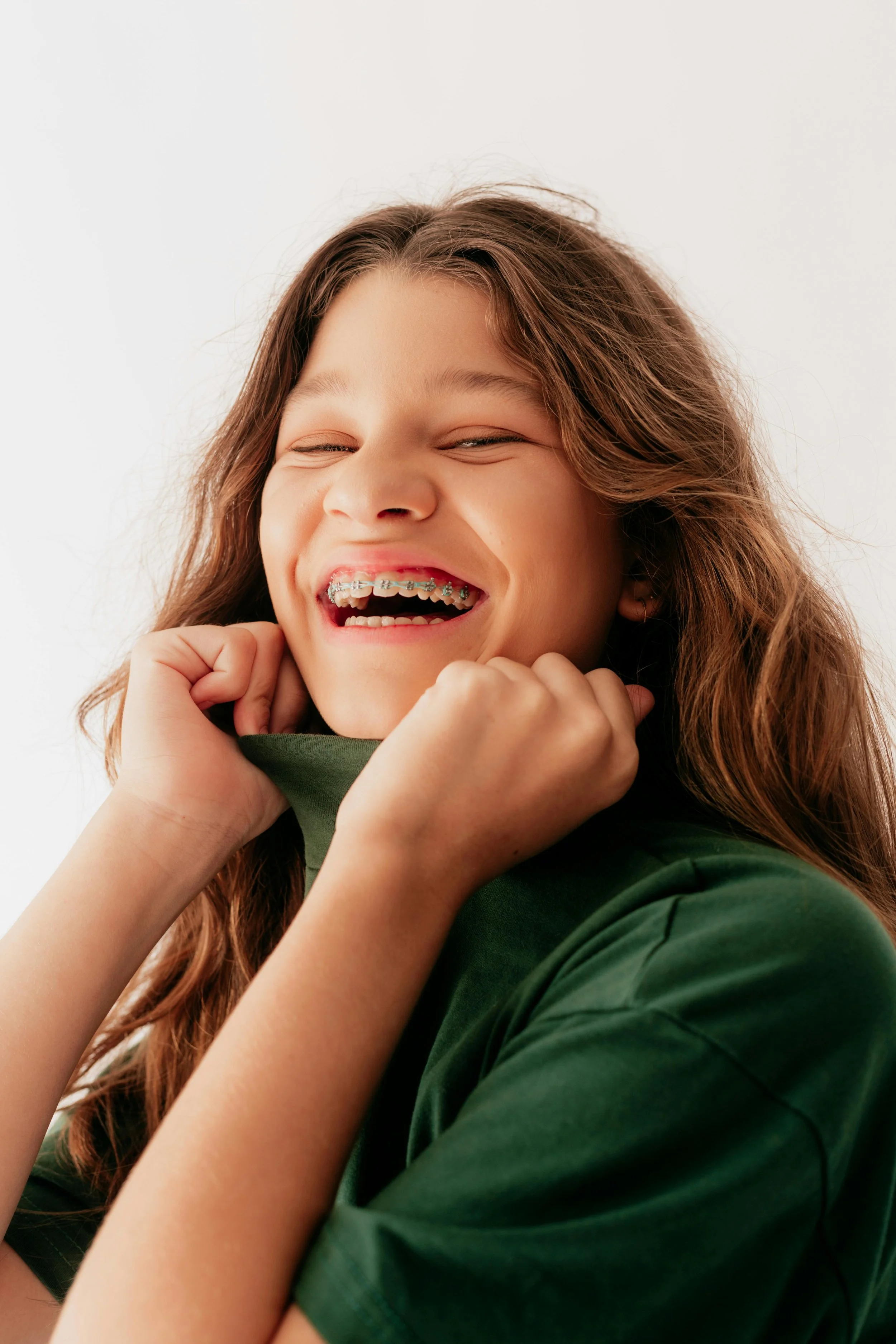 Smiling girl with braces on her teeth