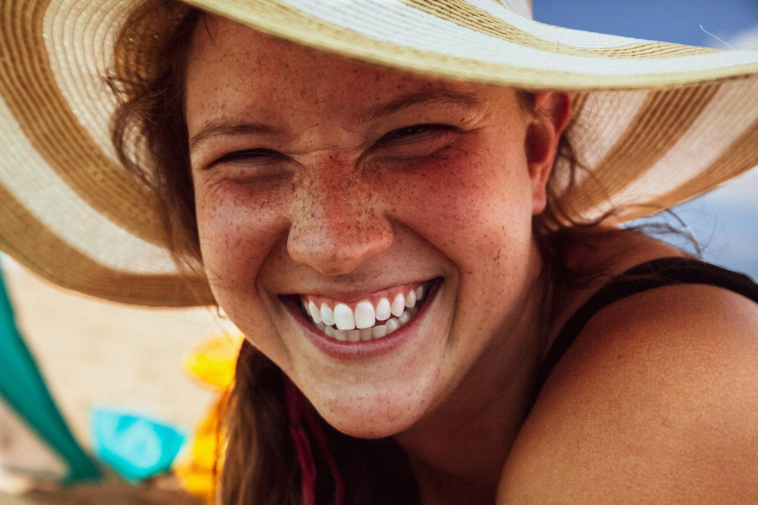 Freckled woman wearing a sunhat smiling