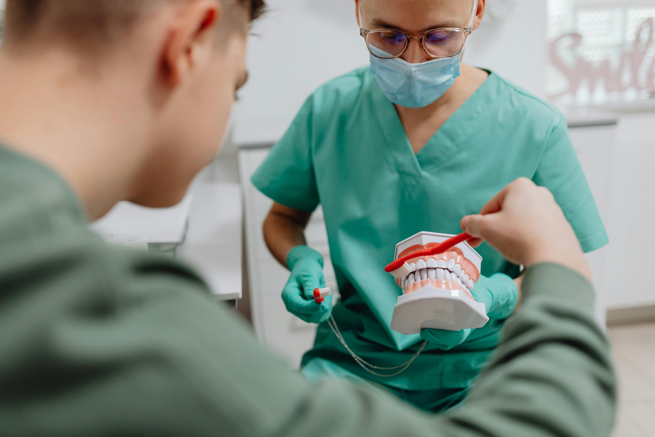 Oral health demonstration showing how to brush teeth effectively.