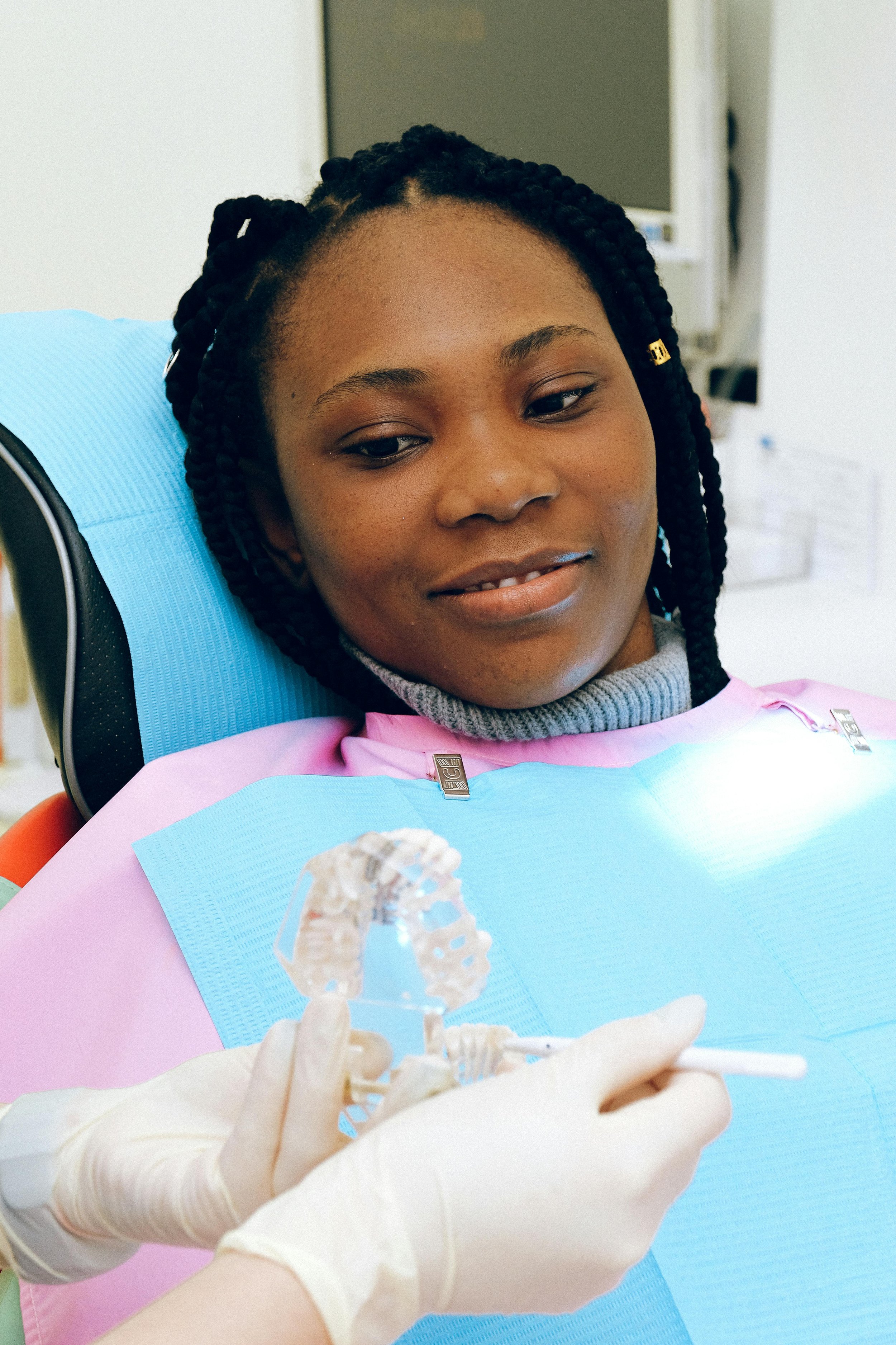 Dentist describing a treatment to a patient using a dental model