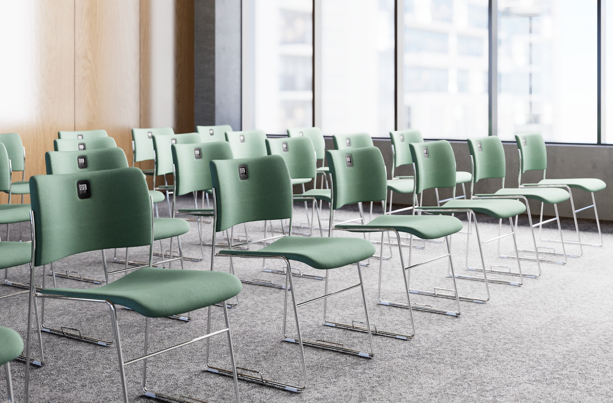 Close-up of a beige fabric chair with metal armrests next to a dark wooden table in a modern interior.