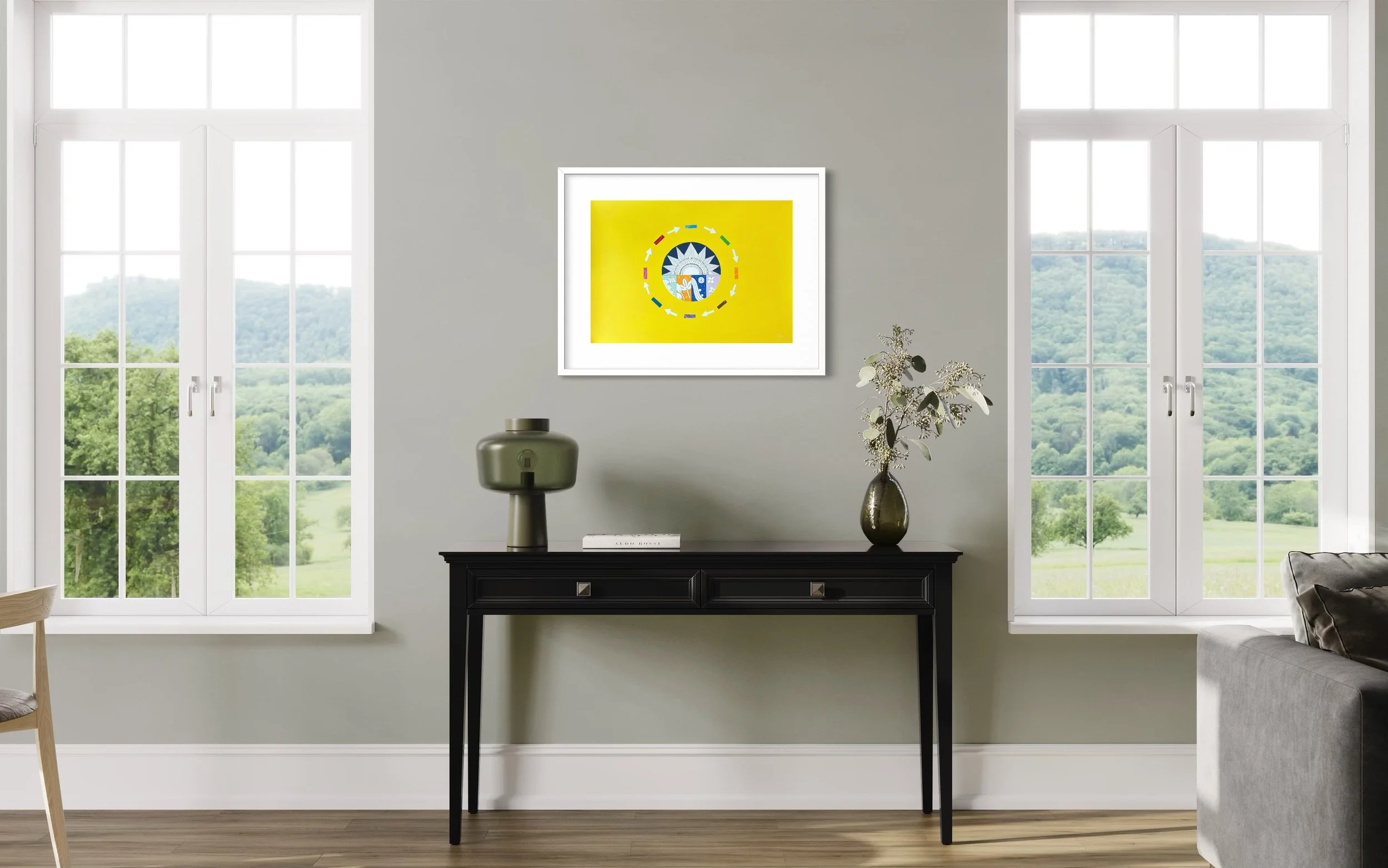 A Most Colourful Year Around the Sun, original mixed media on A2 paper with a yellow background featuring a sun, seasonal panels, and arrows, framed and displayed in a modern living room.